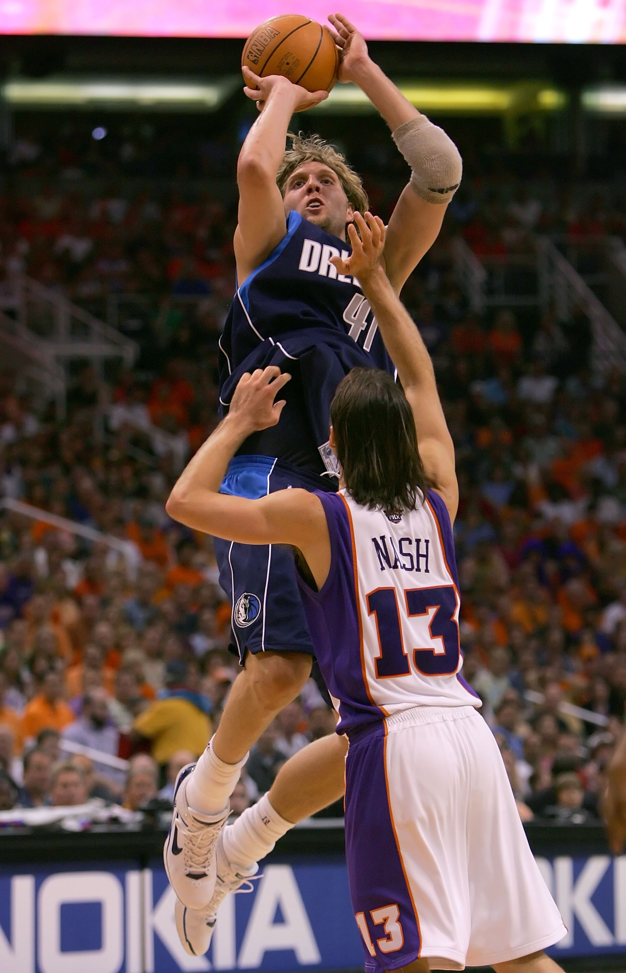 PHOENIX - MAY 28:  Dirk Nowitzki #41 of the Dallas Mavericks shoots over Steve Nash #13 of the Phoenix Suns in game three of the Western Conference Finals during the 2006 NBA Playoffs on May 28, 2006 at US Airways Center in Phoenix, Arizona.  The Maverick