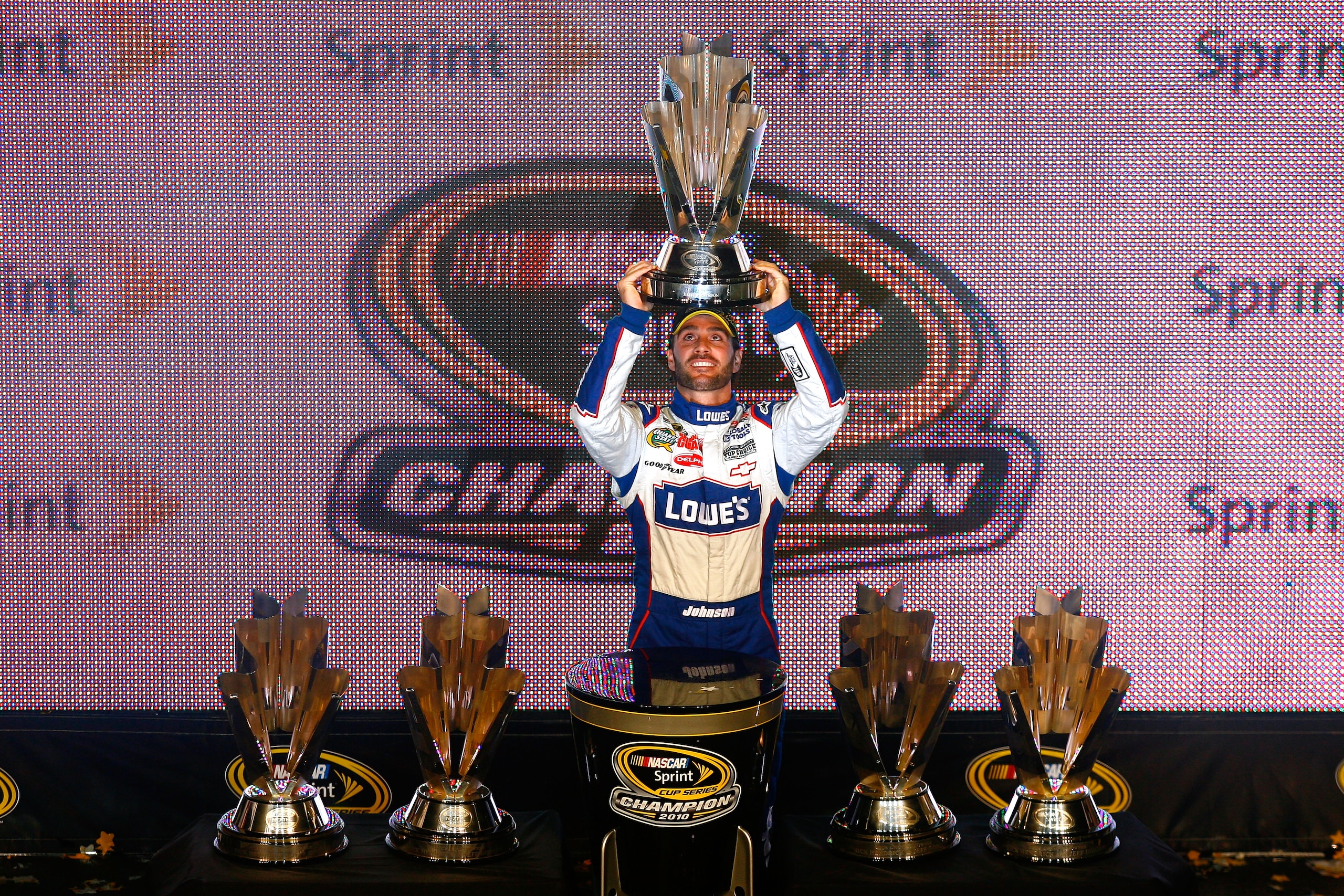 HOMESTEAD, FL - NOVEMBER 21:  Jimmie Johnson, driver of the #48 Lowe's Chevrolet, celebrates after finishing in second place in the Ford 400 to clinch his fifth consecutive NASCAR Sprint Cup championship at Homestead-Miami Speedway on November 21, 2010 in