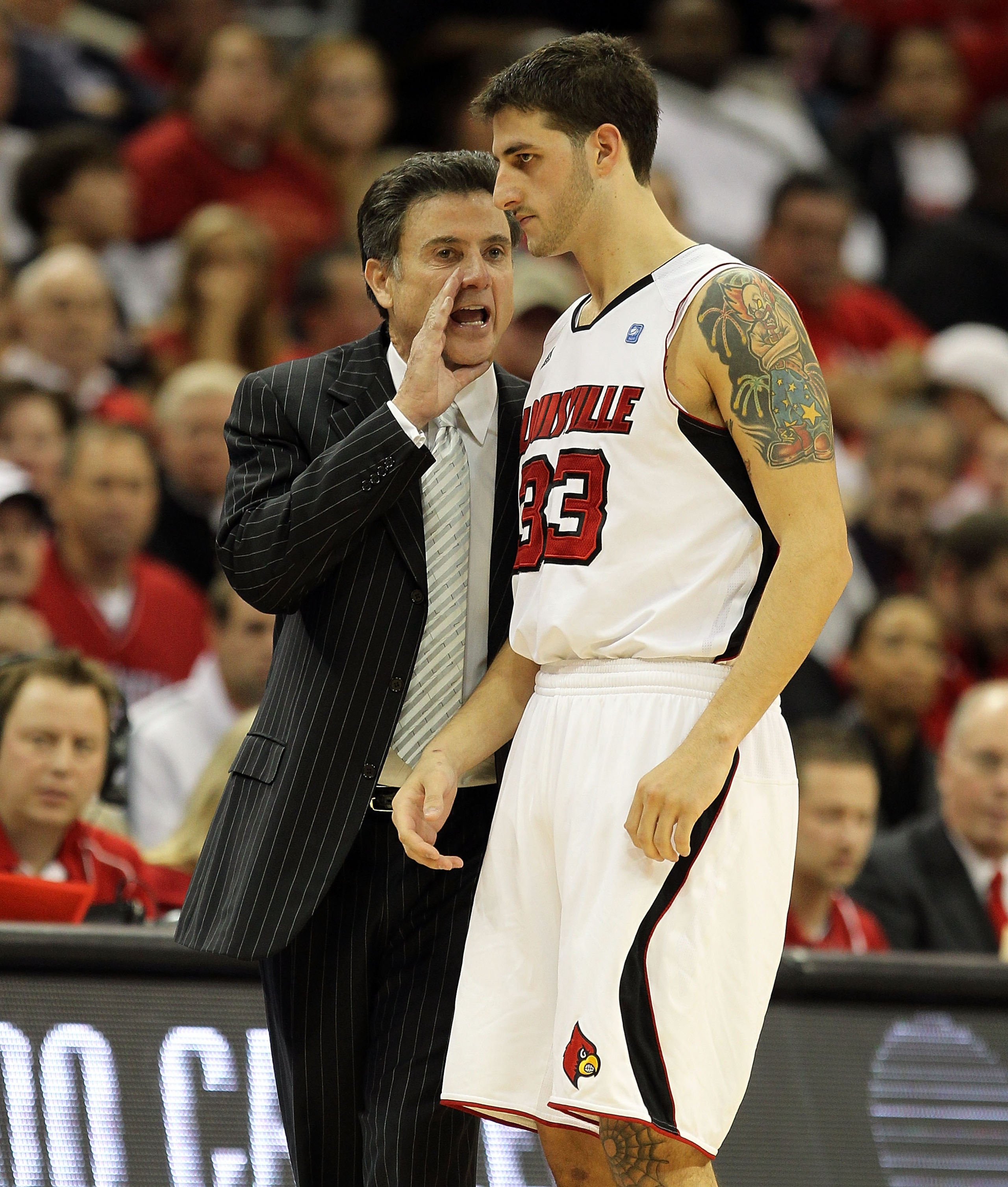 LOUISVILLE, KY - DECEMBER 11: Rick Pitino the Head Coach of the Louisville Cardinals gives instructions to Mike Marra #33 during the game against the UNLV Runnin' Rebels at KFC YUM! Center on December 11, 2010 in Louisville, Kentucky. (Photo by Andy Lyo LOUISVILLE, KY - DECEMBER 11: Rick Pitino the Head Coach of the Louisville Cardinals gives instructions to Mike Marra #33 during the game against the UNLV Runnin' Rebels at KFC YUM! Center on December 11, 2010 in Louisville, Kentucky. (Photo by Andy Lyo