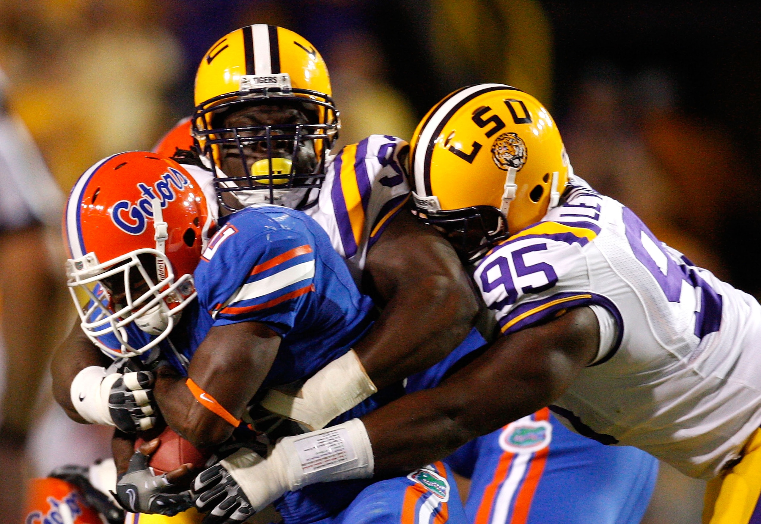 BATON ROUGE, LA - OCTOBER 10:  Drake Nevis #92 and Lazarius Levingston #95 of the Louisiana State University Tigers tackle Jeffery Demps #2 of the Florida Gators at Tiger Stadium on October 10, 2009 in Baton Rouge, Louisiana.  (Photo by Kevin C. Cox/Getty