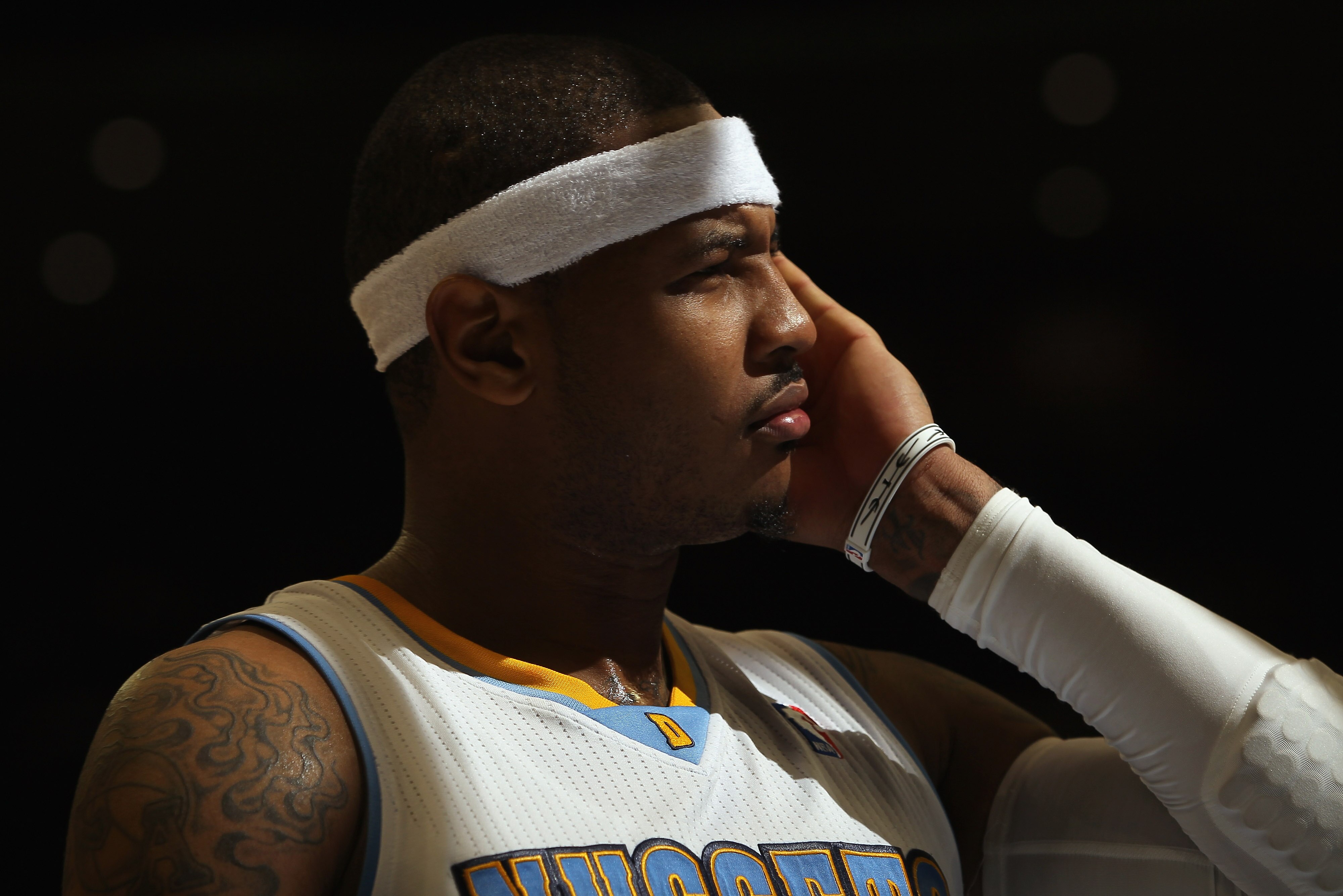DENVER - NOVEMBER 16:  Carmelo Anthony #15 of the Denver Nuggets looks on during a break in the action against the New York Knicks at the Pepsi Center on November 16, 2010 in Denver, Colorado. The Nuggets defeated the Knicks 120-118. NOTE TO USER: User ex