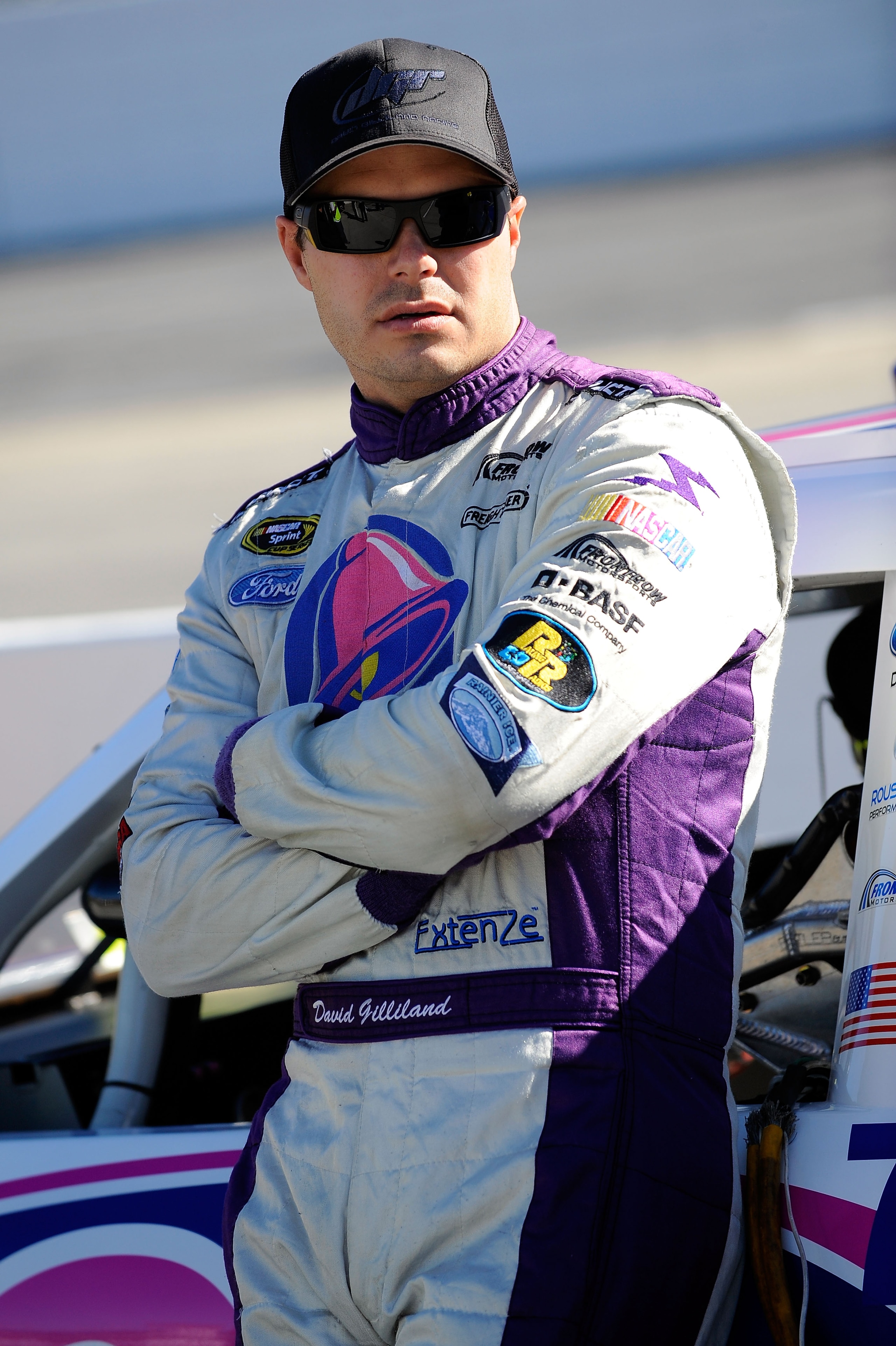 MARTINSVILLE, VA - OCTOBER 22:  David Gilliland, driver of the #37 Taco Bell Ford, stands on pit road during qualifying for the NASCAR Sprint Cup Series TUMS Fast Relief 500 at Martinsville Speedway on October 22, 2010 in Martinsville, Virginia.  (Photo b