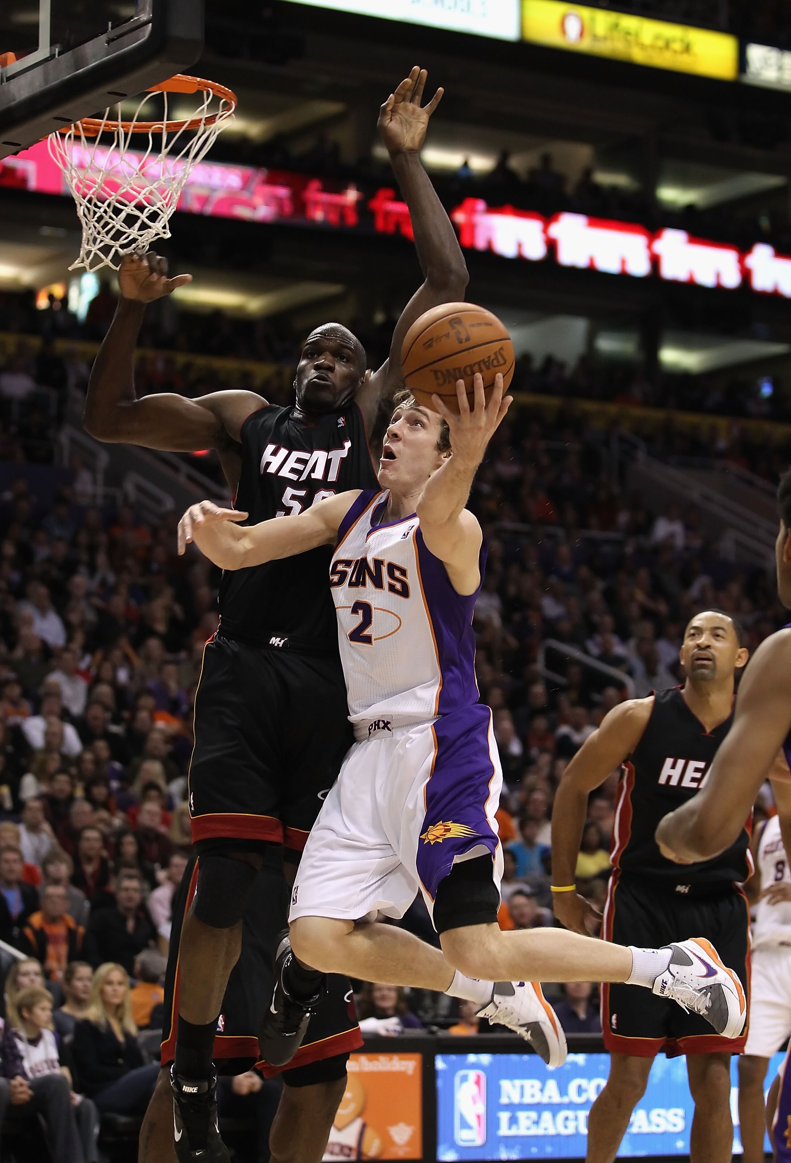 PHOENIX - DECEMBER 23:  Goran Dragic #2 of the Phoenix Suns puts up a shot past Joel Anthony #50 of the Miami Heat during the NBA game at US Airways Center on December 23, 2010 in Phoenix, Arizona. The Heat defeated the Suns 95-83.  NOTE TO USER: User exp
