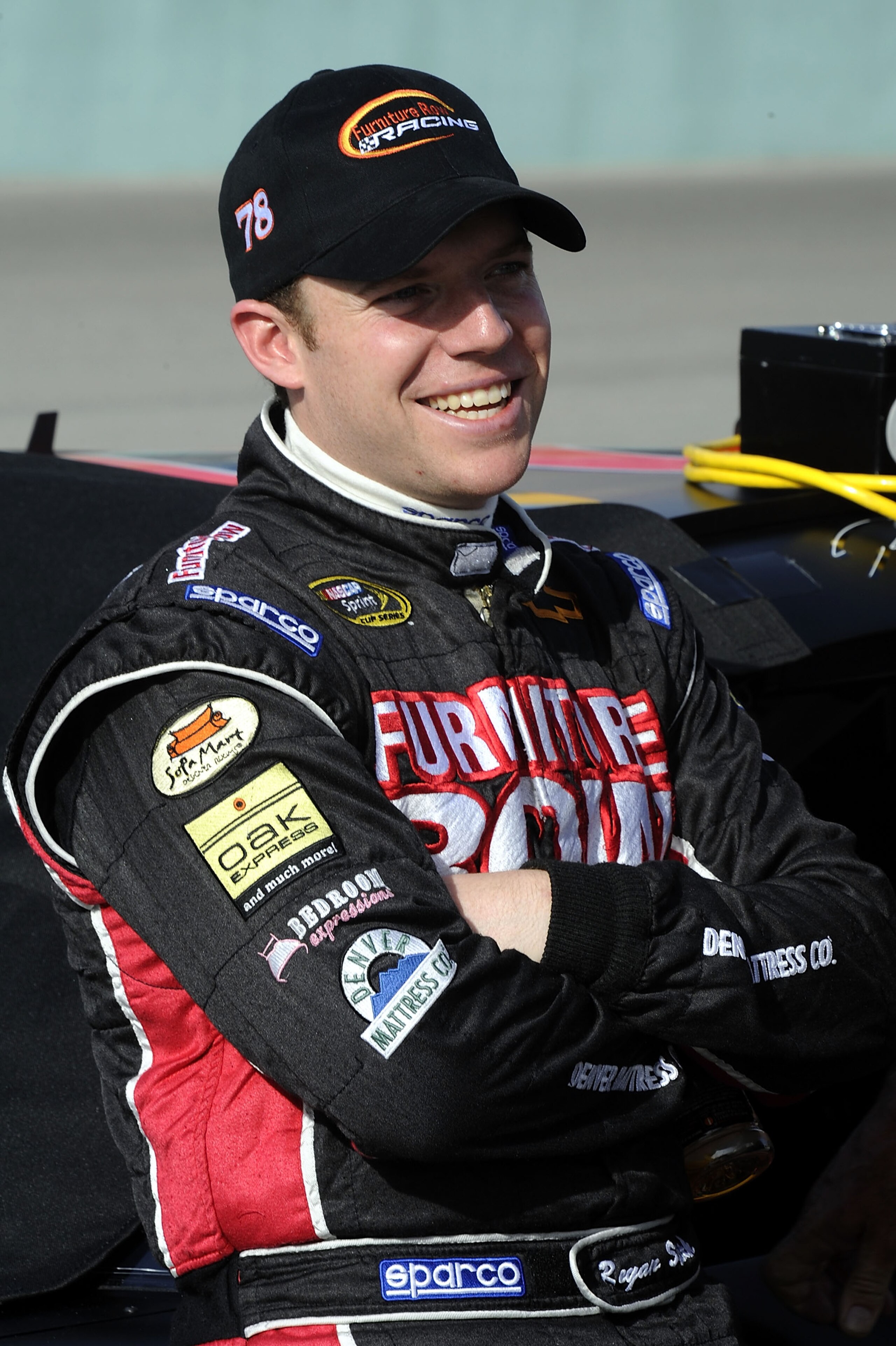 HOMESTEAD, FL - NOVEMBER 19:  Regan Smith, driver of the #78 Furniture Row Racing Chevrolet, stands on pit road during qualifying for the NASCAR Sprint Cup Series Ford 400 at Homestead-Miami Speedway on November 19, 2010 in Homestead, Florida.  (Photo by