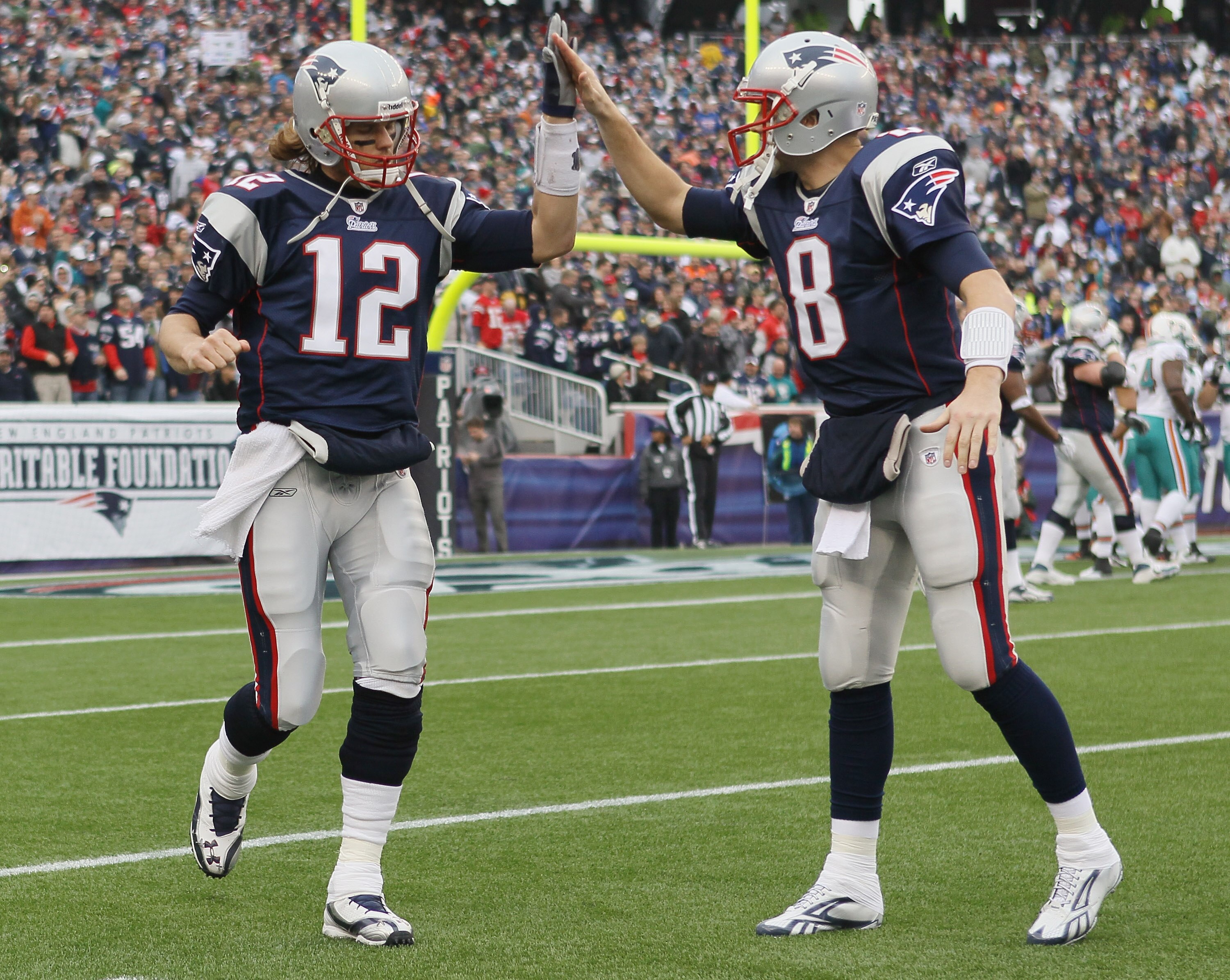 FOXBORO, MA - JANUARY 02:  Tom Brady #12of the New England Patriots celebrates the touchdown with teammate Brian Hoyer #8 in the first half against the Miami Dolphins on January 2, 2011 at Gillette Stadium in Foxboro, Massachusetts.  (Photo by Elsa/Getty