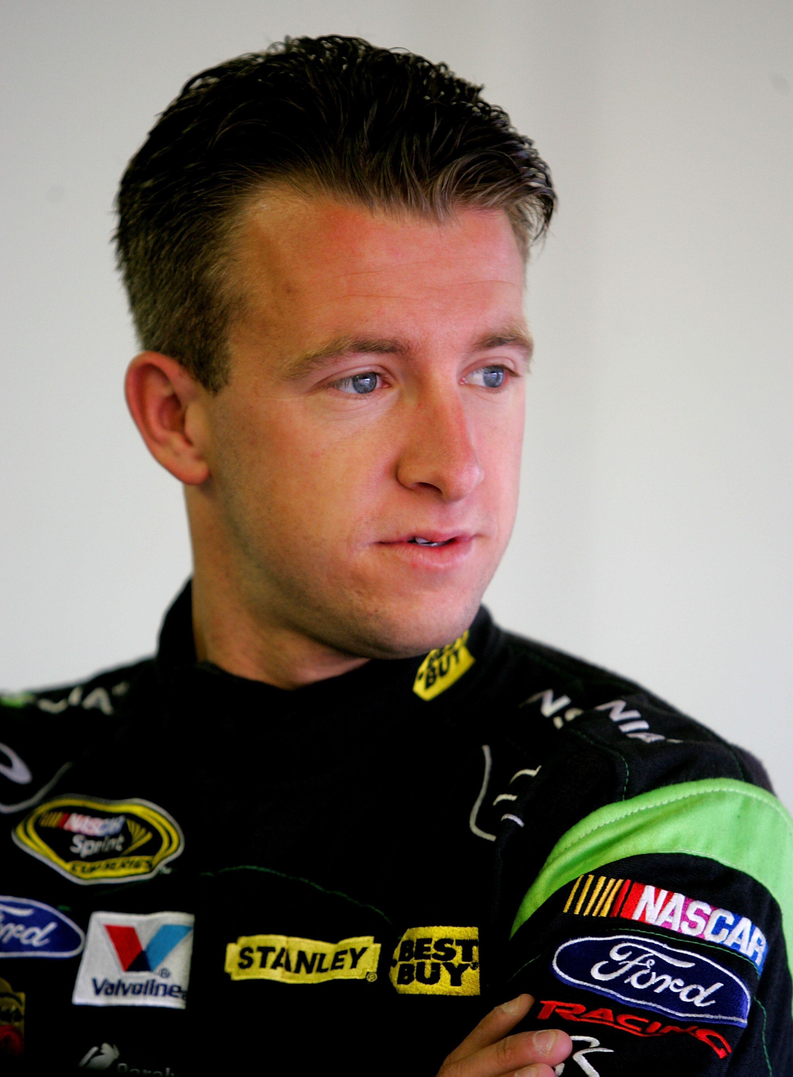 LOUDON, NH - SEPTEMBER 18:  A J Allmendinger, driver of the #43 Insignia HDTV Ford, stands in the garage during practice for the NASCAR Sprint Cup Series Sylvania 300 at New Hampshire Motor Speedway on September 18, 2010 in Loudon, New Hampshire.  (Photo