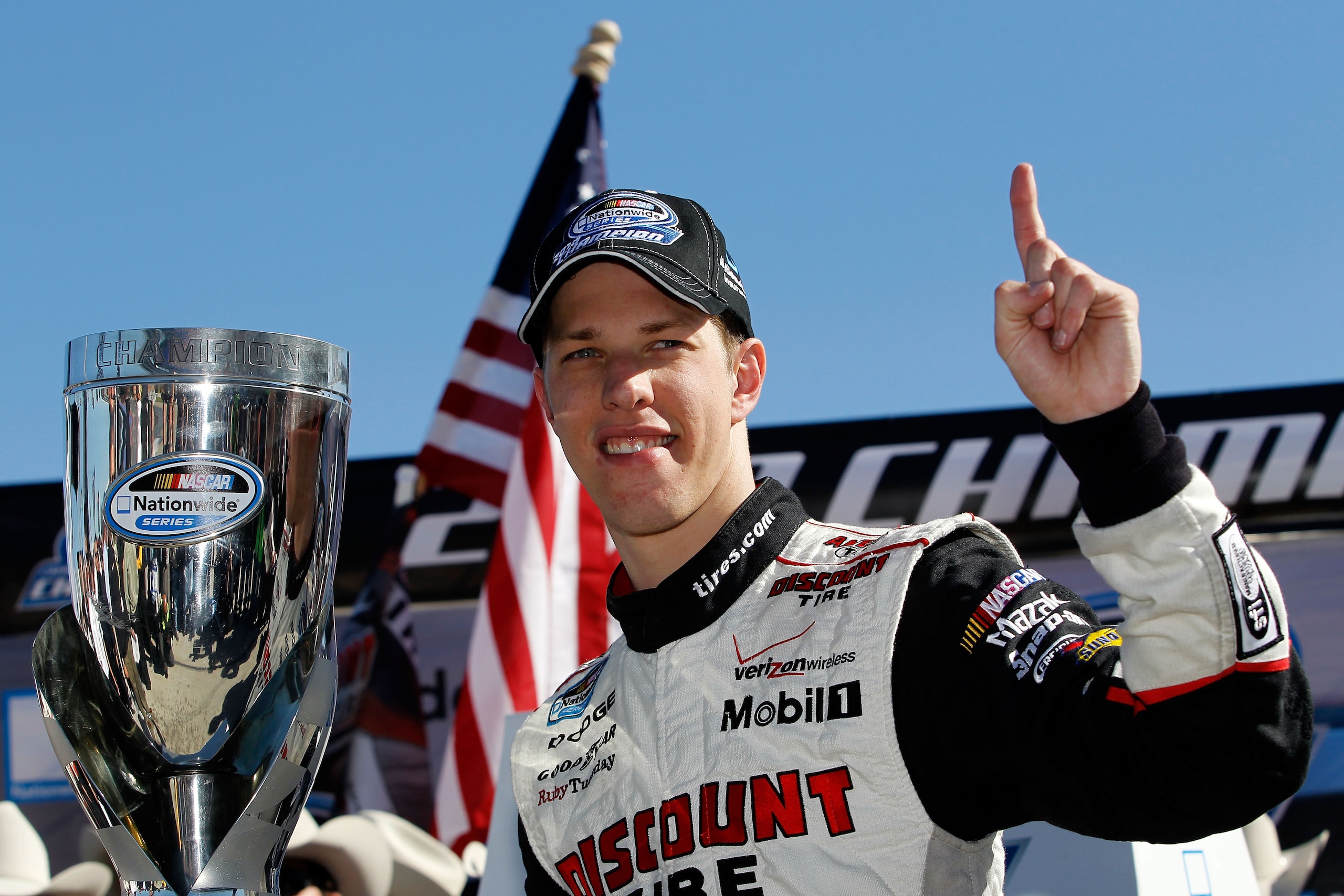 FORT WORTH, TX - NOVEMBER 06:  Brad Keselowski, driver of the #22 Discount Tire Dodge, celebrates after winning the Nationwide Championship with a third-place finish in the NASCAR Nationwide Series O'Reilly Auto Parts Challenge at Texas Motor Speedway on