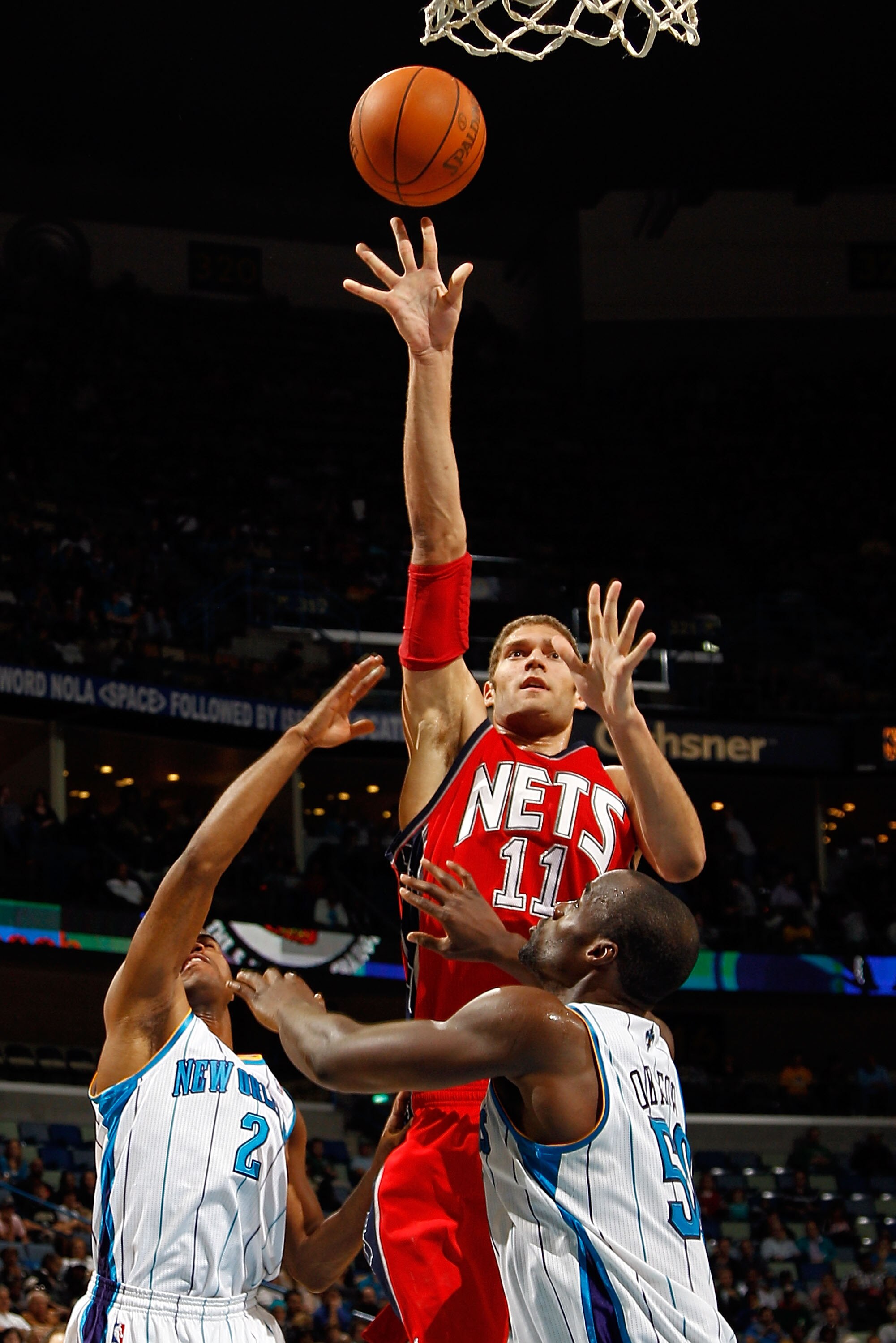 NEW ORLEANS, LA - DECEMBER 22:  Brook Lopez #11 of the New Jersey Nets shoots the ball over Emeka Okafor #50 of the New Orleans Hornets at the New Orleans Arena on December 22, 2010 in New Orleans, Louisiana.    The Hornets defeated the Nets 105-91.   NOT