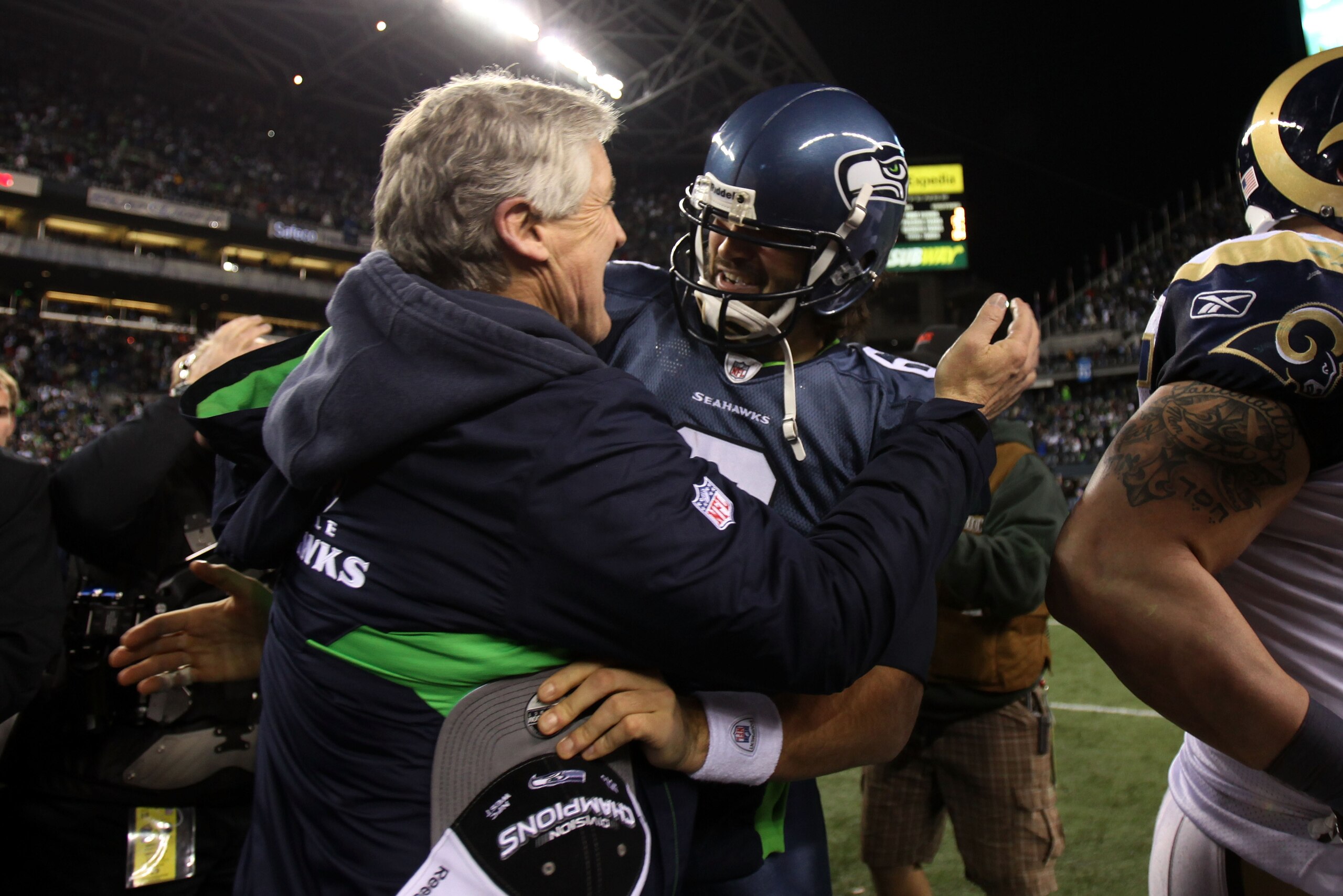 SEATTLE, WA - JANUARY 02: Head coach Pete Carroll of the Seattle Seahawks hugs quarterback Charlie Whitehurst #6 after defeating the St. Louis Rams 16-6 at Qwest Field on January 2, 2011 in Seattle, Washington. The Seahawks became the first team to advan SEATTLE, WA - JANUARY 02: Head coach Pete Carroll of the Seattle Seahawks hugs quarterback Charlie Whitehurst #6 after defeating the St. Louis Rams 16-6 at Qwest Field on January 2, 2011 in Seattle, Washington. The Seahawks became the first team to advan