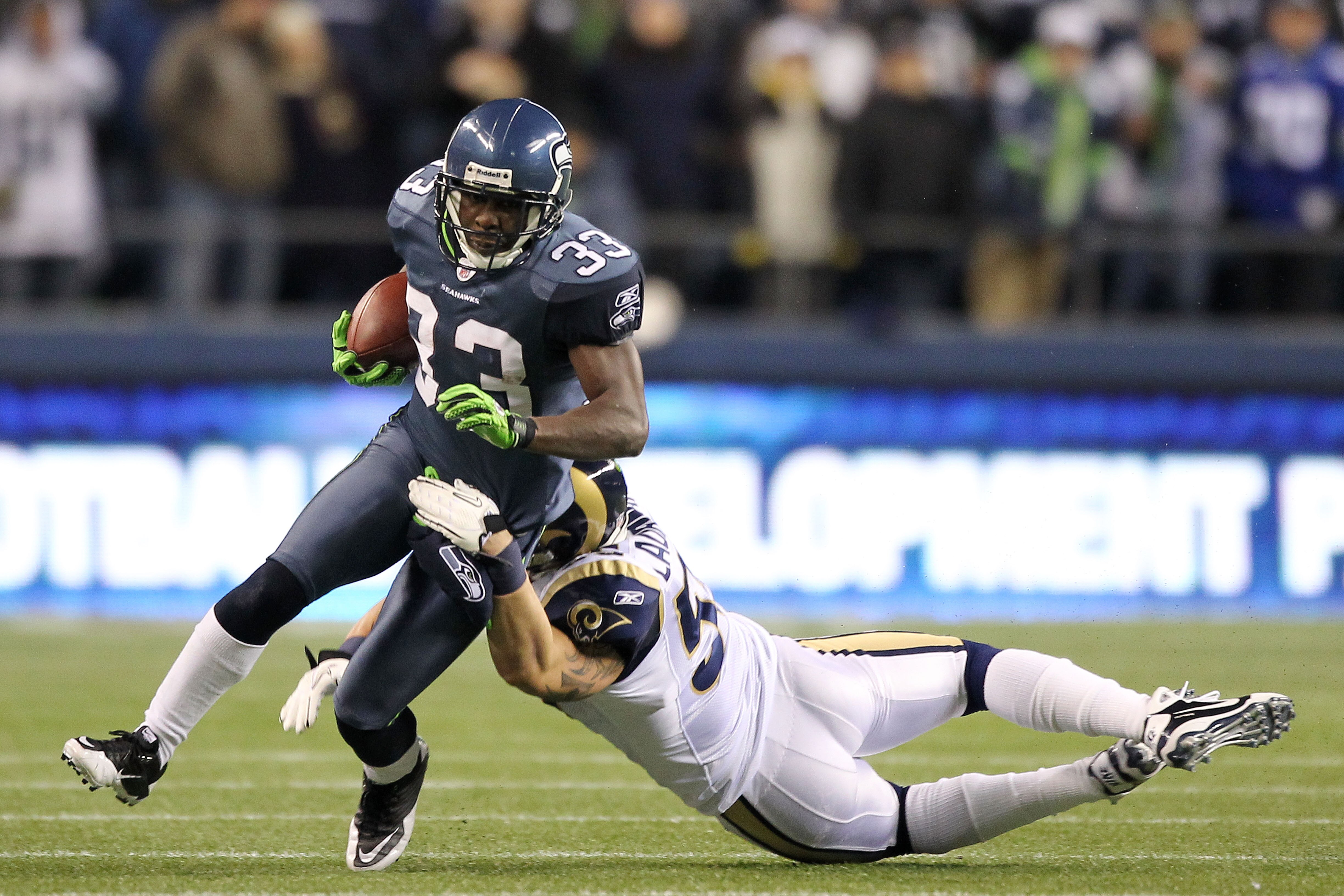 SEATTLE, WA - JANUARY 02:  Leon Washington #33 of the Seattle Seahawks is tackled by James Laurinaitis #55 of the St. Louis Rams during their game at Qwest Field on January 2, 2011 in Seattle, Washington.  (Photo by Otto Greule Jr/Getty Images)