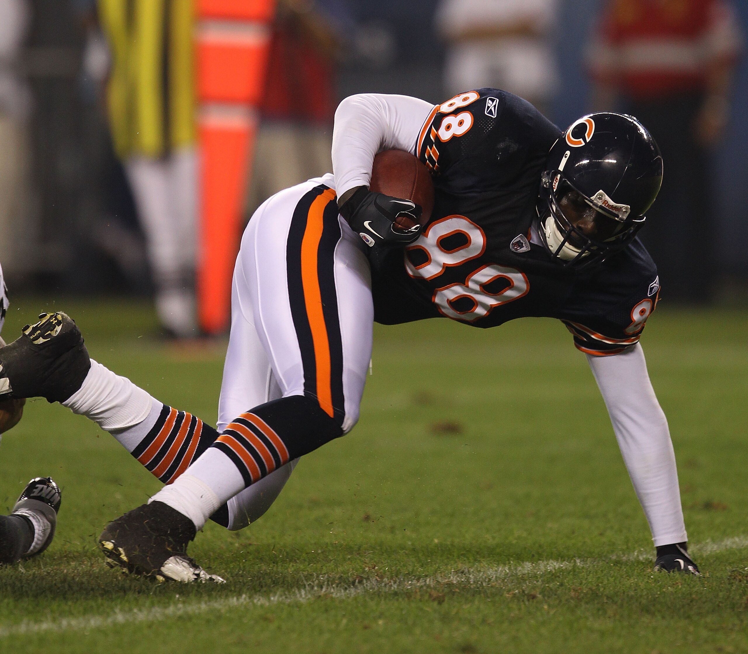 CHICAGO - AUGUST 21: Desmond Clark #88 of the Chicago Bears tries to keep his balance after catching a pass against the Oakland Raiders during a preseason game at Soldier Field on August 21, 2010 in Chicago, Illinois. The Raiders defeated the Bears 32-17.