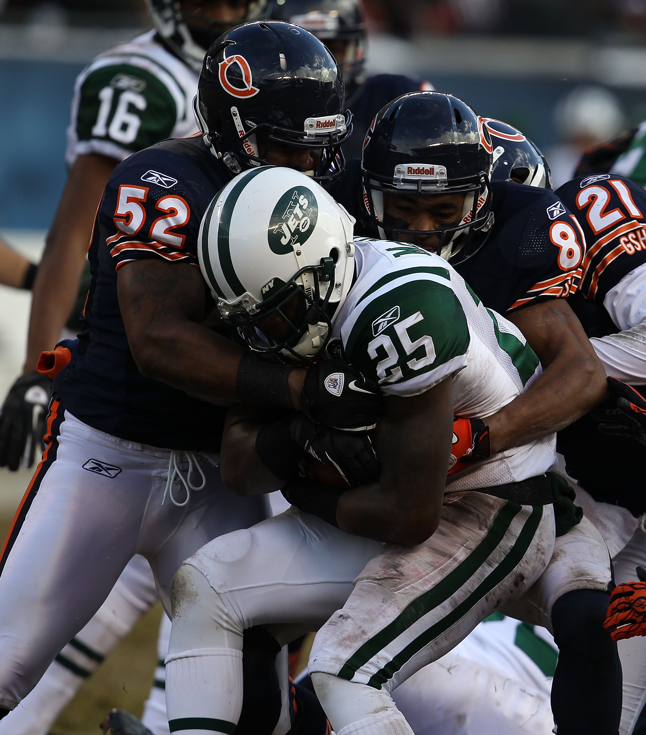 CHICAGO, IL - DECEMBER 26: Joe McKnight #25 of the New York Jets is tackled by Brian Iwuh #52, Rashied Davis #81 and Corey Graham #21 of the Chicago Bears at Soldier Field on December 26, 2010 in Chicago, Illinois. The Bears defeated the Jets 38-34. (Phot