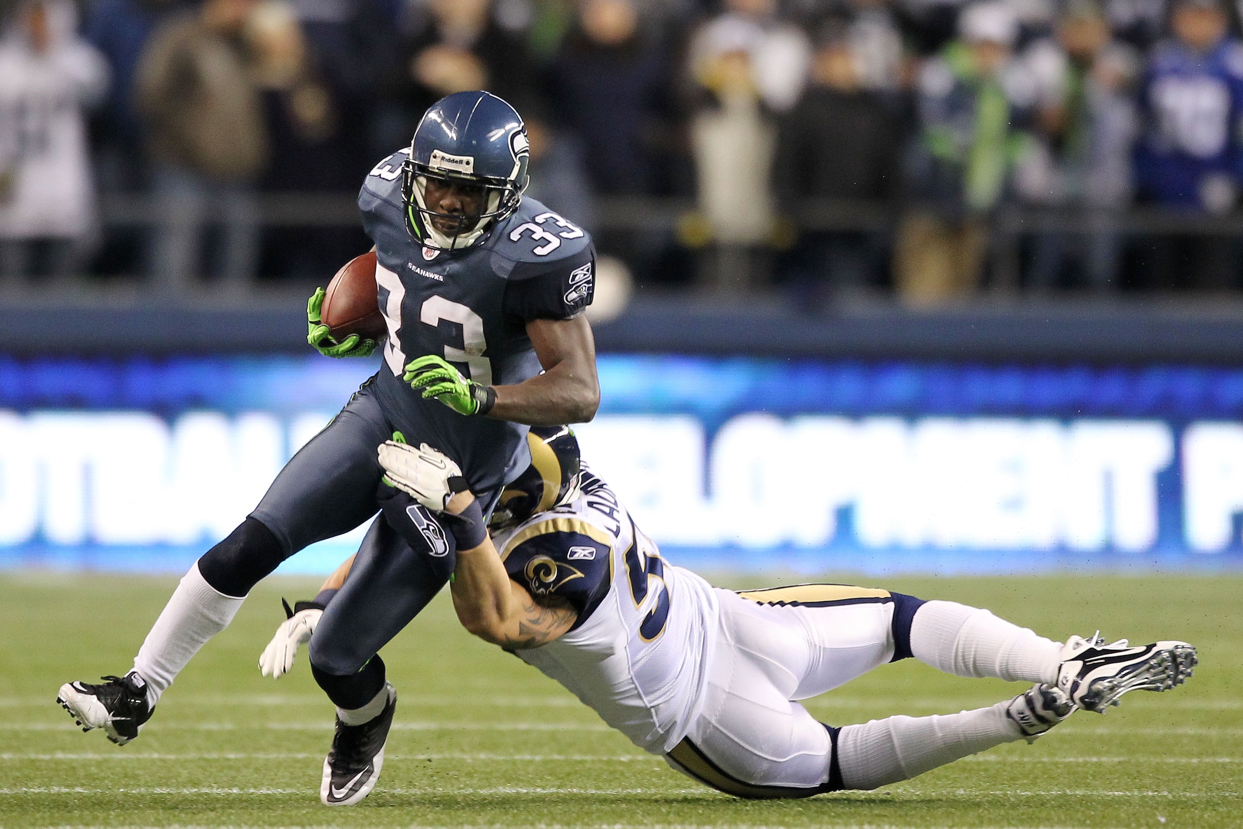 SEATTLE, WA - JANUARY 02:  Leon Washington #33 of the Seattle Seahawks is tackled by James Laurinaitis #55 of the St. Louis Rams during their game at Qwest Field on January 2, 2011 in Seattle, Washington.  (Photo by Otto Greule Jr/Getty Images)