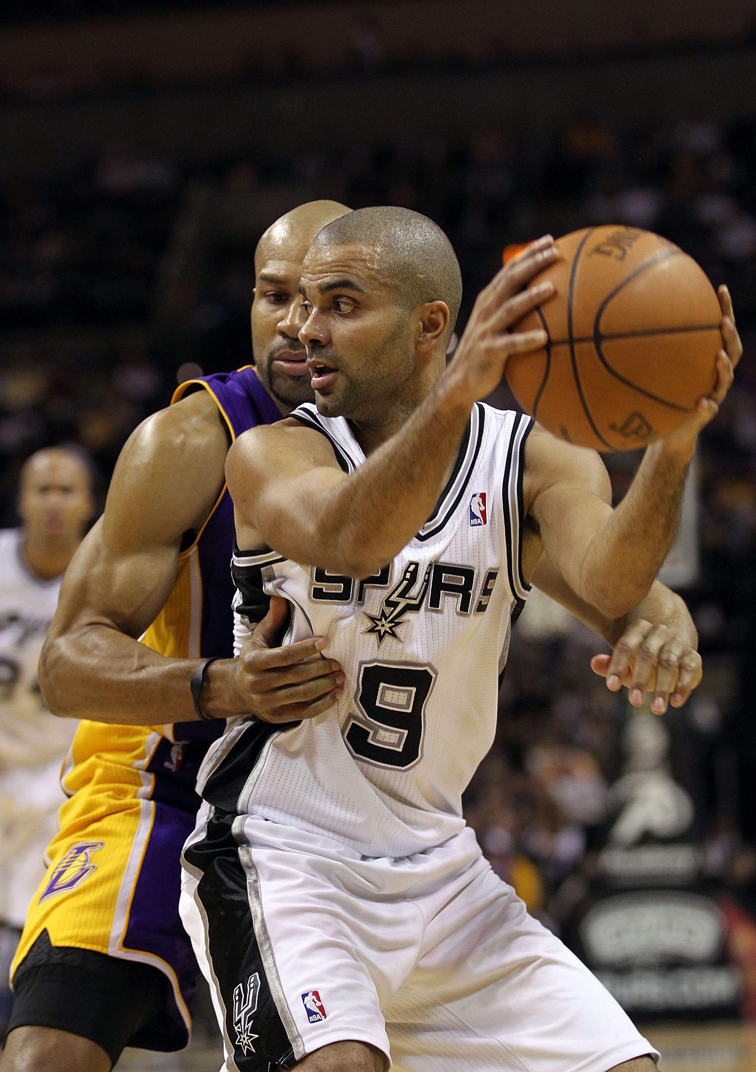SAN ANTONIO, TX - DECEMBER 28:  Guard Tony Parker #9 of the San Antonio Spurs dribbles the ball against Derek Fisher #2 of the Los Angeles Lakers at AT&T Center on December 28, 2010 in San Antonio, Texas.    NOTE TO USER: User expressly acknowledges and a