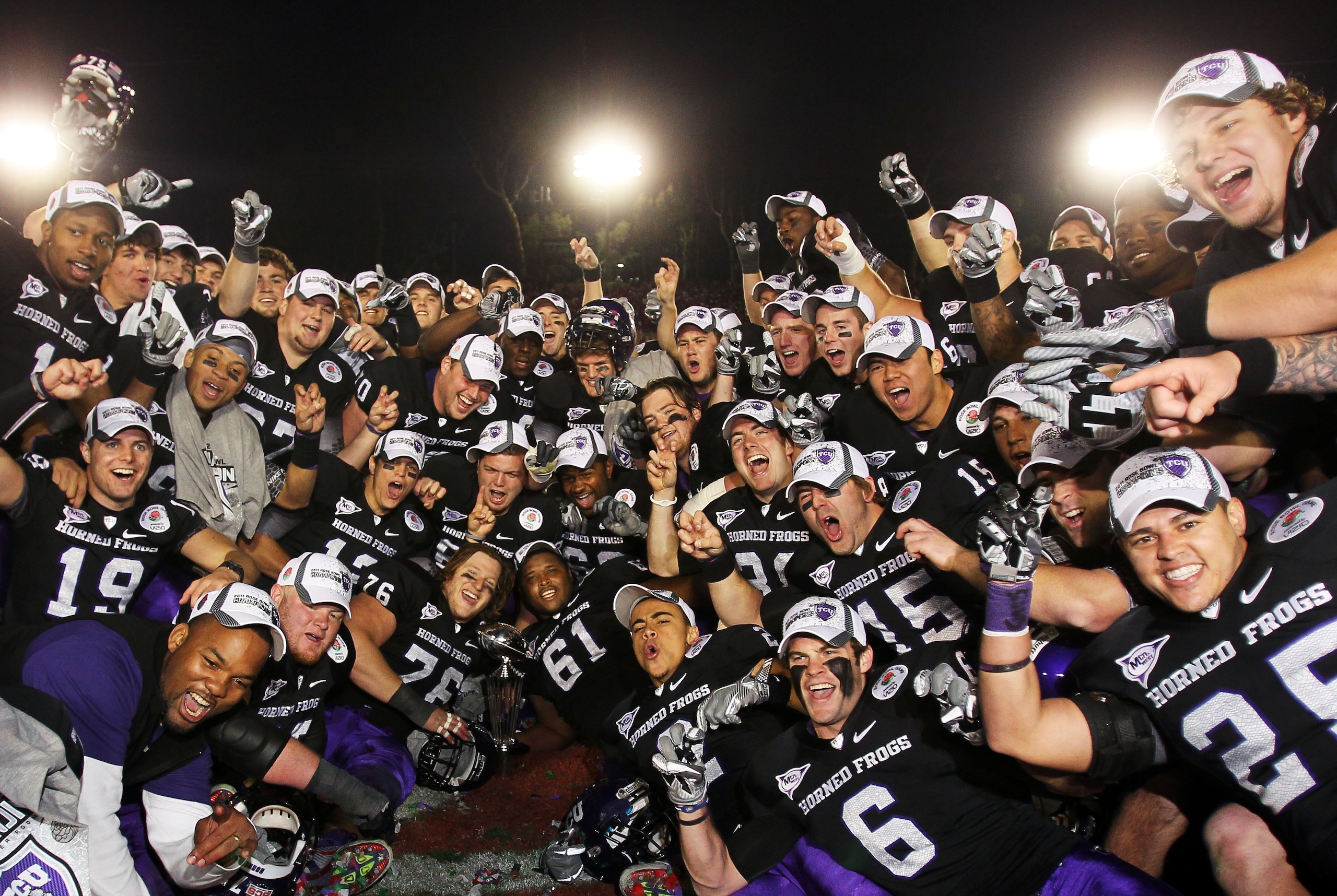 PASADENA, CA - JANUARY 01:  The TCU Horned Frogs celebrate with the Rose Bowl Championship Trophy after defeating the Wisconsin Badgers 21-19 in the 97th Rose Bowl game on January 1, 2011 in Pasadena, California.  (Photo by Jeff Gross/Getty Images)