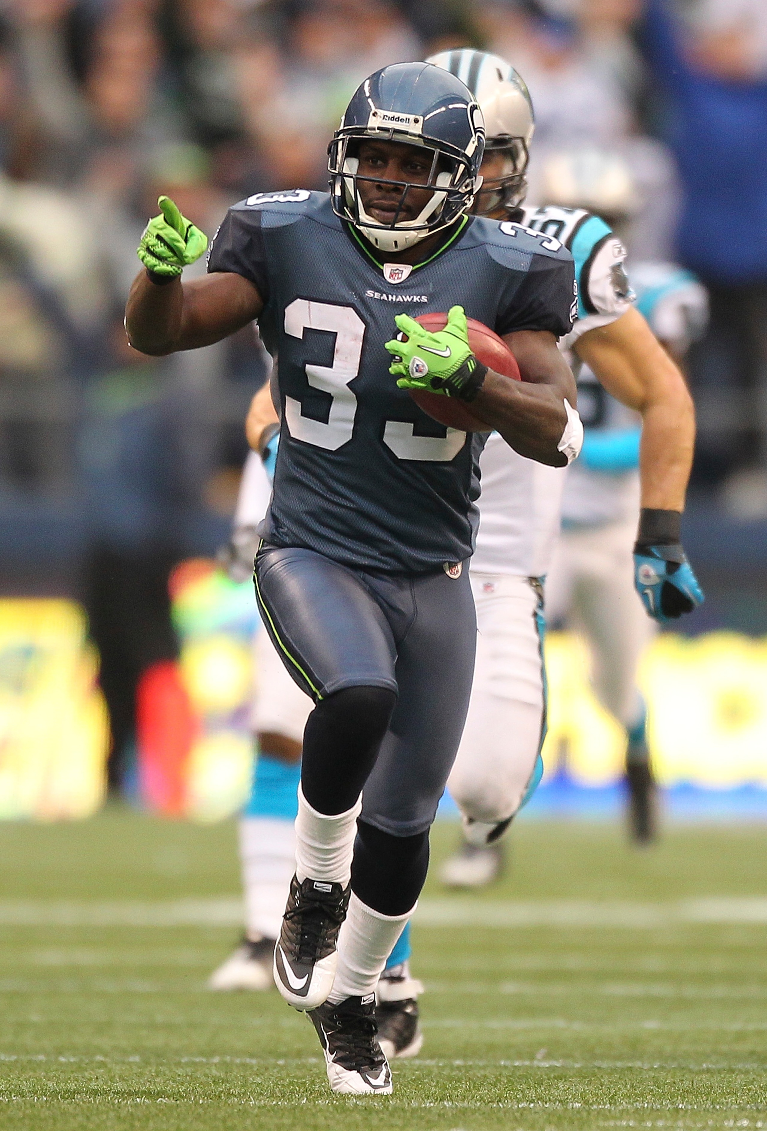 SEATTLE, WA - DECEMBER 05:  Running back Leon Washington #33 of the Seattle Seahawks returns a punt for 84 yards against the Carolina Panthers at Qwest Field on December 5, 2010 in Seattle, Washington. Washington was down at the 2 yard line on the play, a