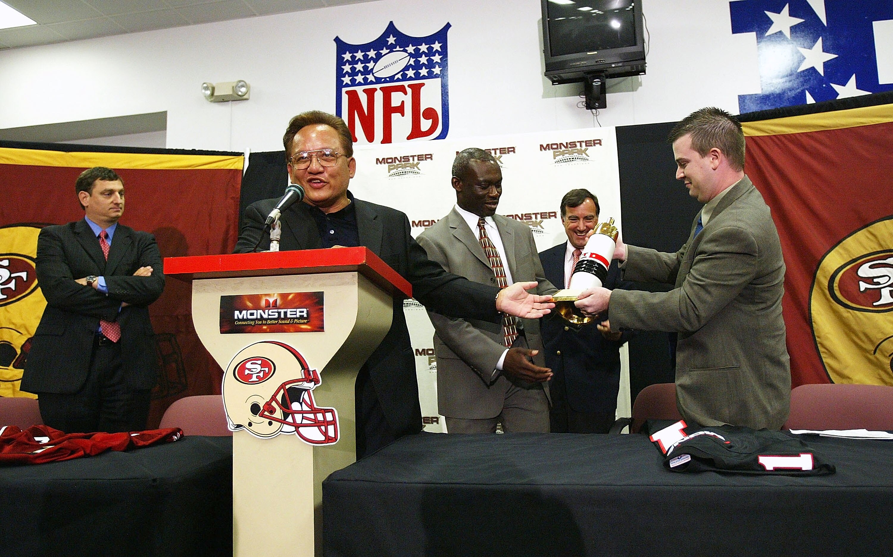 SAN FRANCISCO - SEPTEMBER 28:  Noel Lee (2nd-L), founder of Monster Cable Company, presents gifts at a press conference announcing the naming rights of the San Francisco 49ers stadium to 'Monster Park' on September 28, 2004 at Monster Park in San Francisc