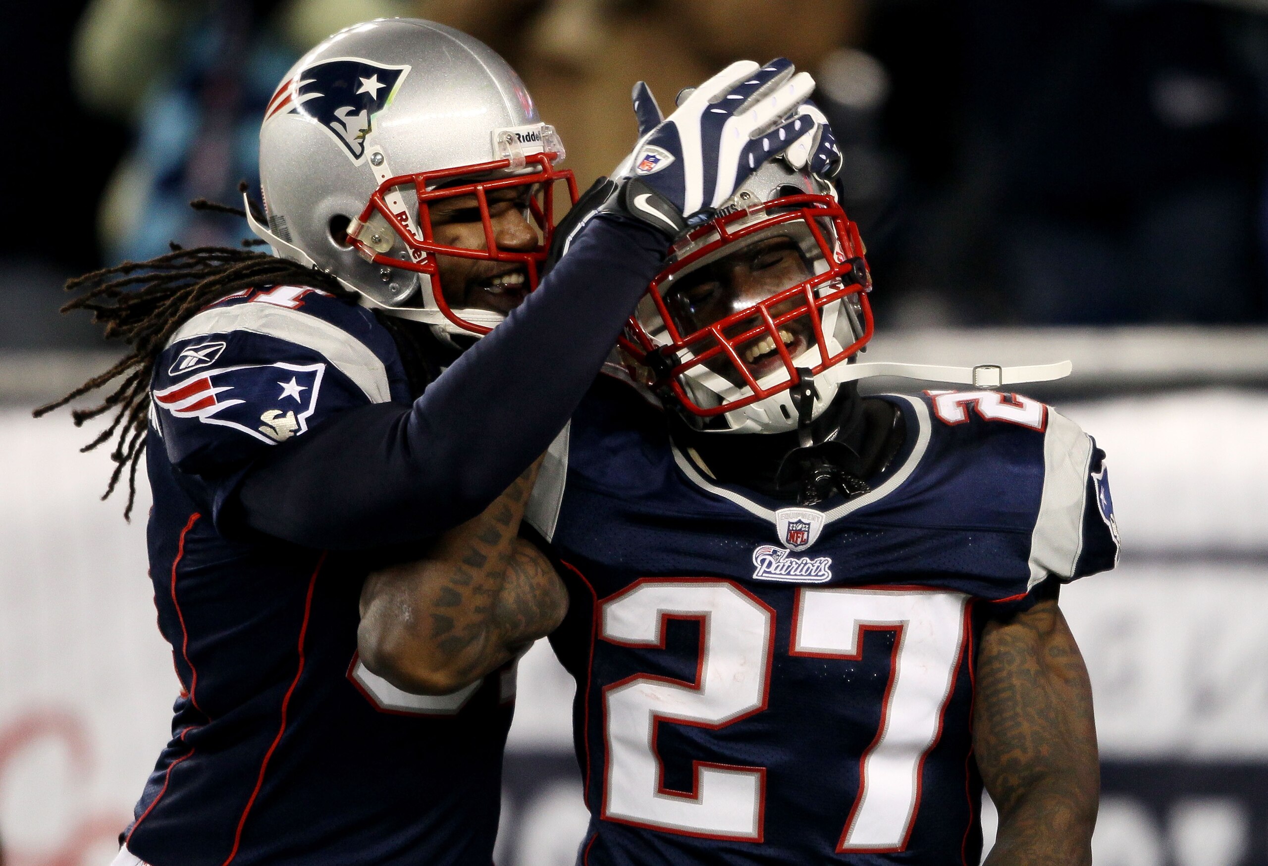 FOXBORO, MA - DECEMBER 19:  Cornerback Kyle Arrington #27 of the New England Patriots (R) is congratulated for scoring a touchdown after intercepting the ball and running 36 yards by teammate safety Brandon Meriweather #31 during the third quarter of the