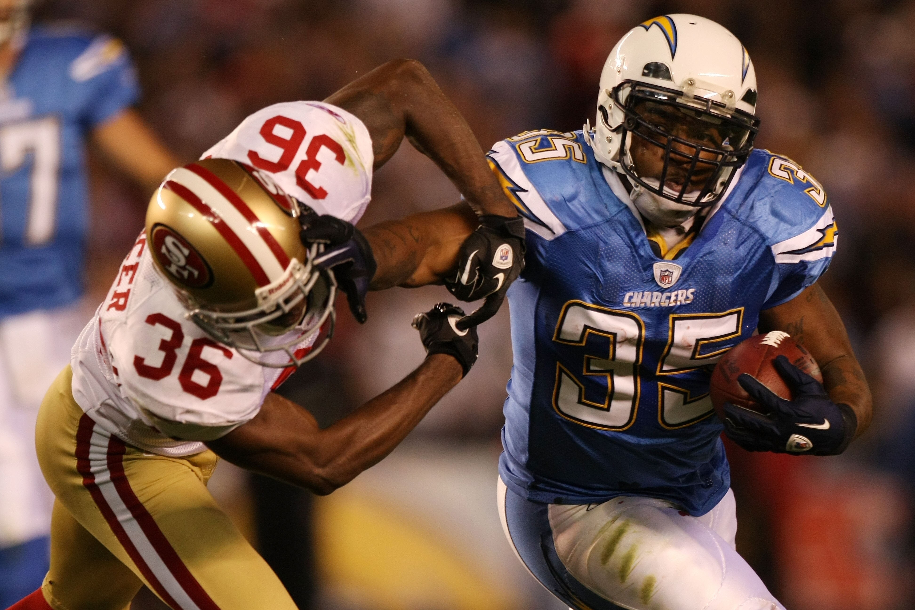 SAN DIEGO, CA - DECEMBER 16:  Running back Mike Tolbert #35 of the San Diego Chargers rushes with the ball as cornerback Shawntae Spencer #36 of the San Francisco 49ers trys to tackle him at Qualcomm Stadium on December 16, 2010 in San Diego, California.