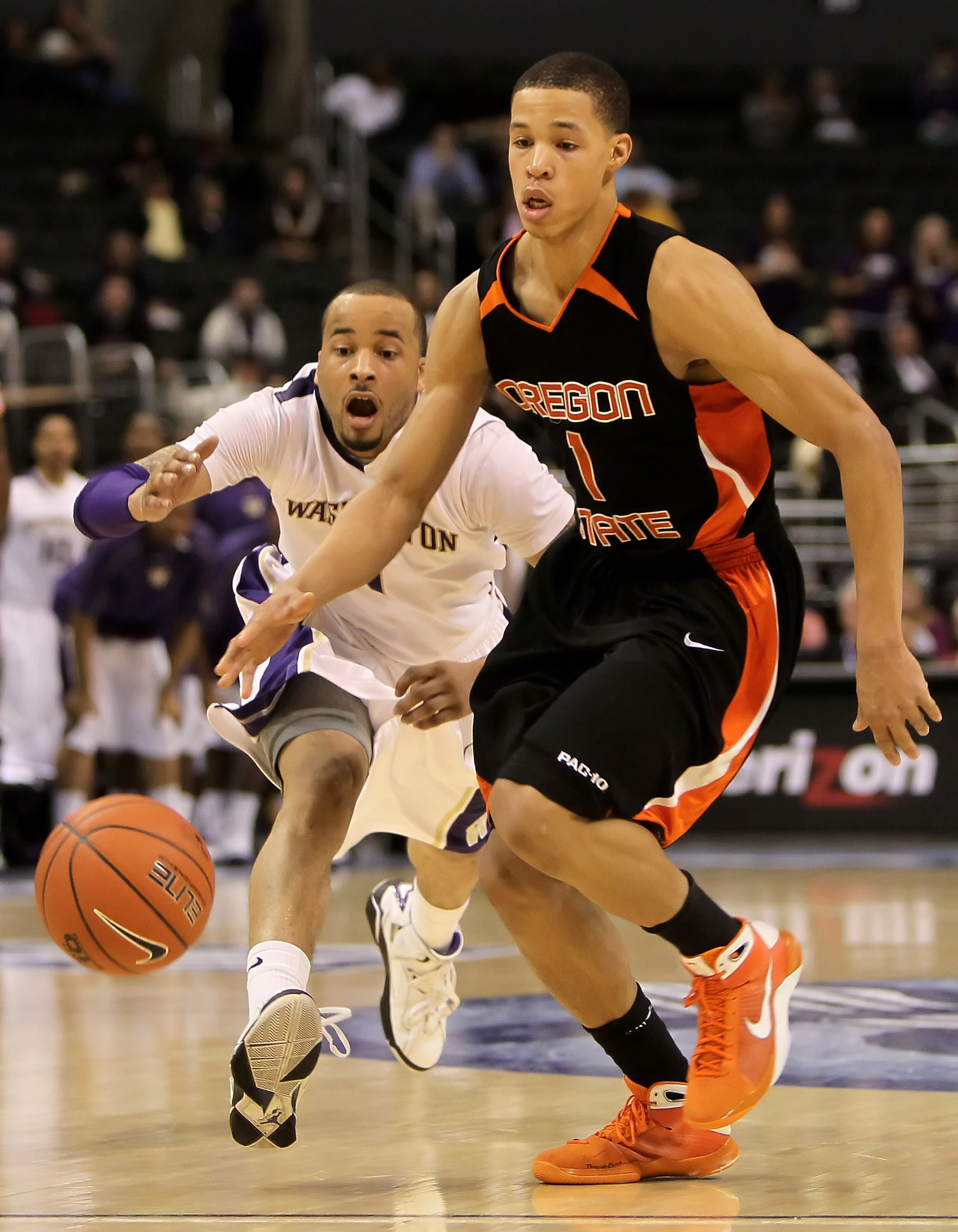 LOS ANGELES, CA - MARCH 11:  Venoy Overton #1 of the Washington Huskies pursues Jared Cunningham #1 of the Oregon State Beavers for the ball in the second half during the Quarterfinals of the Pac-10 Basketball Tournament at Staples Center on March 11, 201