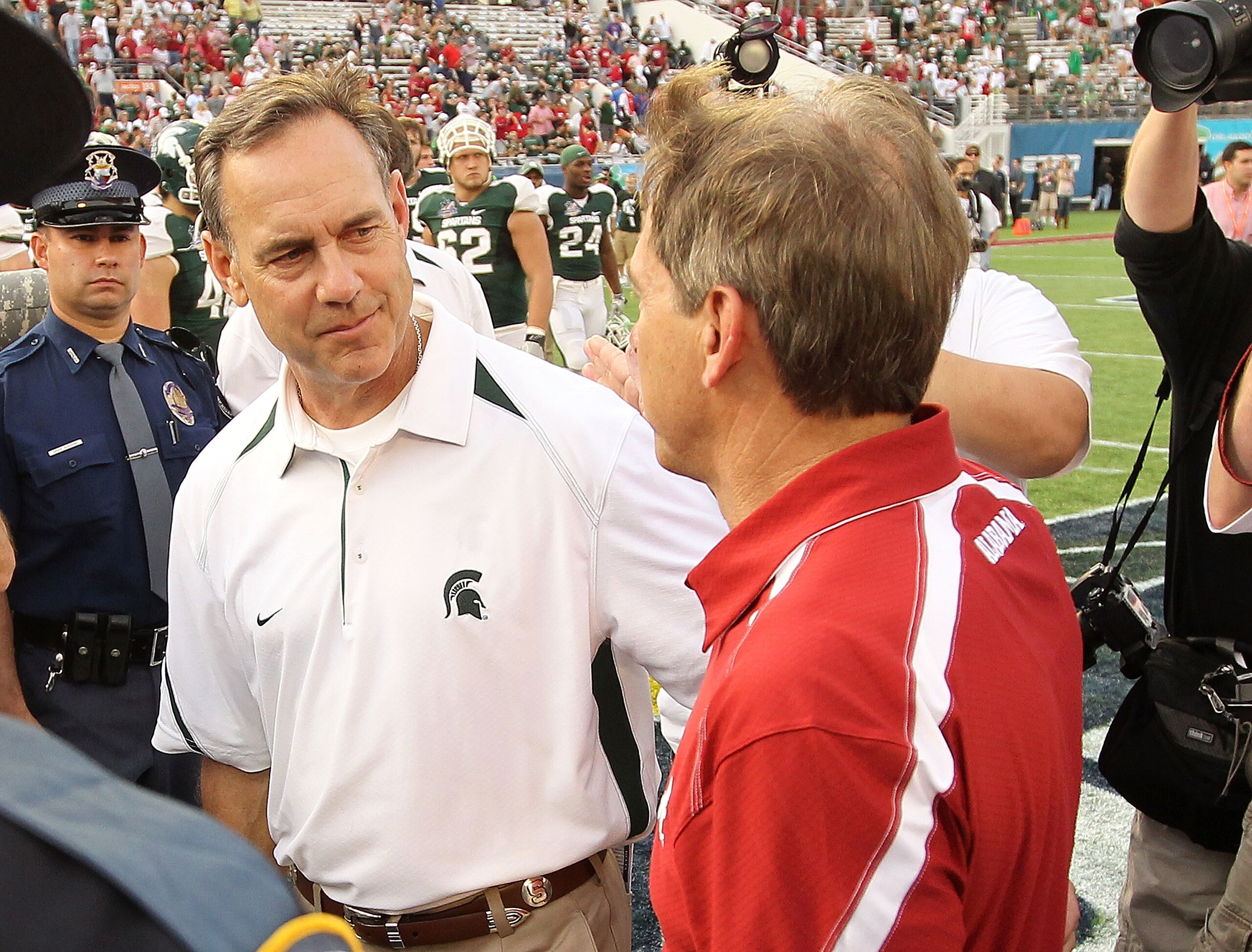 ORLANDO, FL - JANUARY 01:  Alabama Crimson Tide Head Coach Nick Saban greets Michigan State Spartans Head Coach Mark Dantonio after winning the Capitol One Bowl against at the Florida Citrus Bowl on January 1, 2011 in Orlando, Florida.  (Photo by Mike Ehr