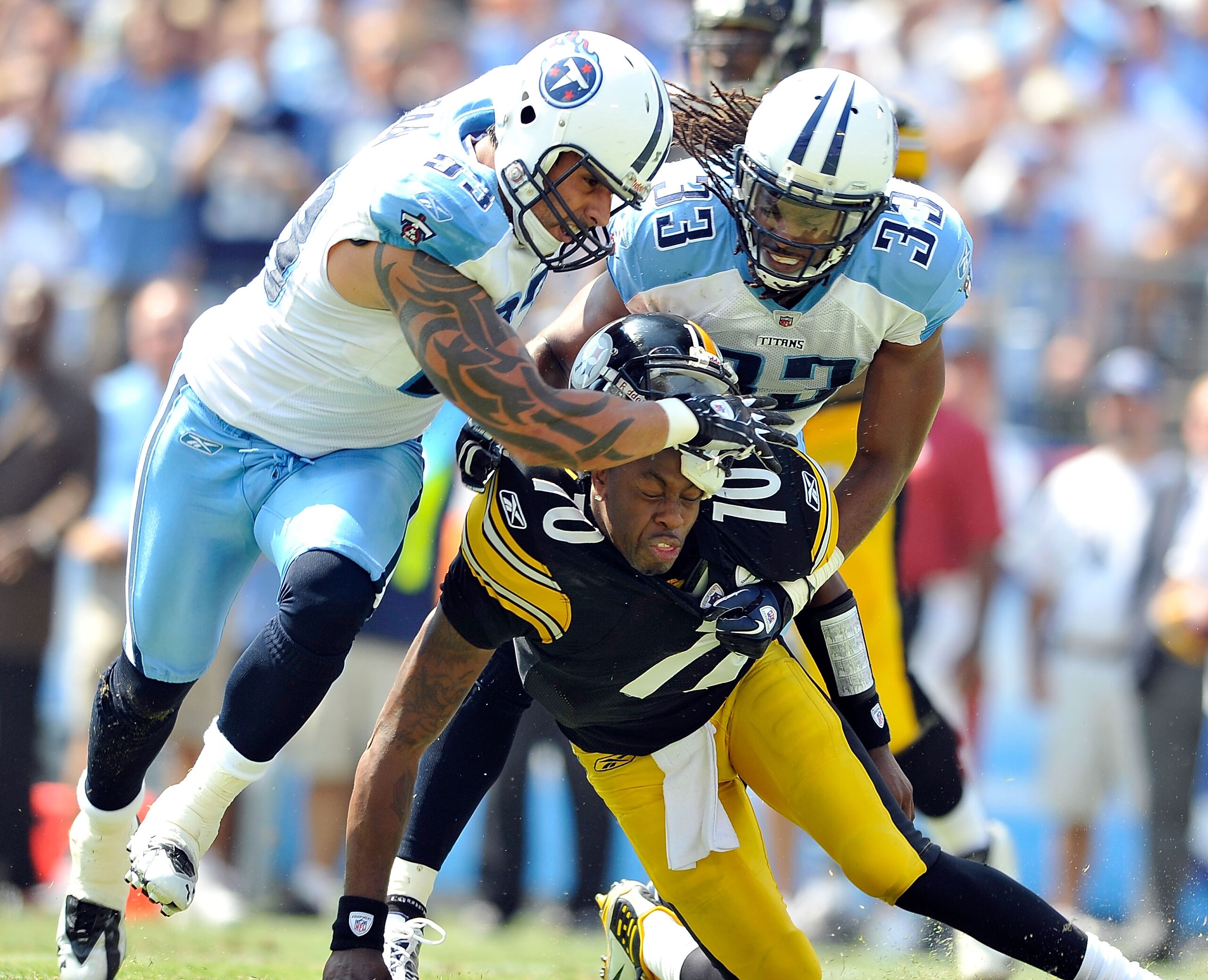 NASHVILLE, TN - SEPTEMBER 19:  Jason Babin #93 and Michael Griffin #33 of the Tennessee Titans pressure quarterback Dennis Dixon #10 of the Pittsburgh Steelers during the first half at LP Field on September 19, 2010 in Nashville, Tennessee.  (Photo by Gra