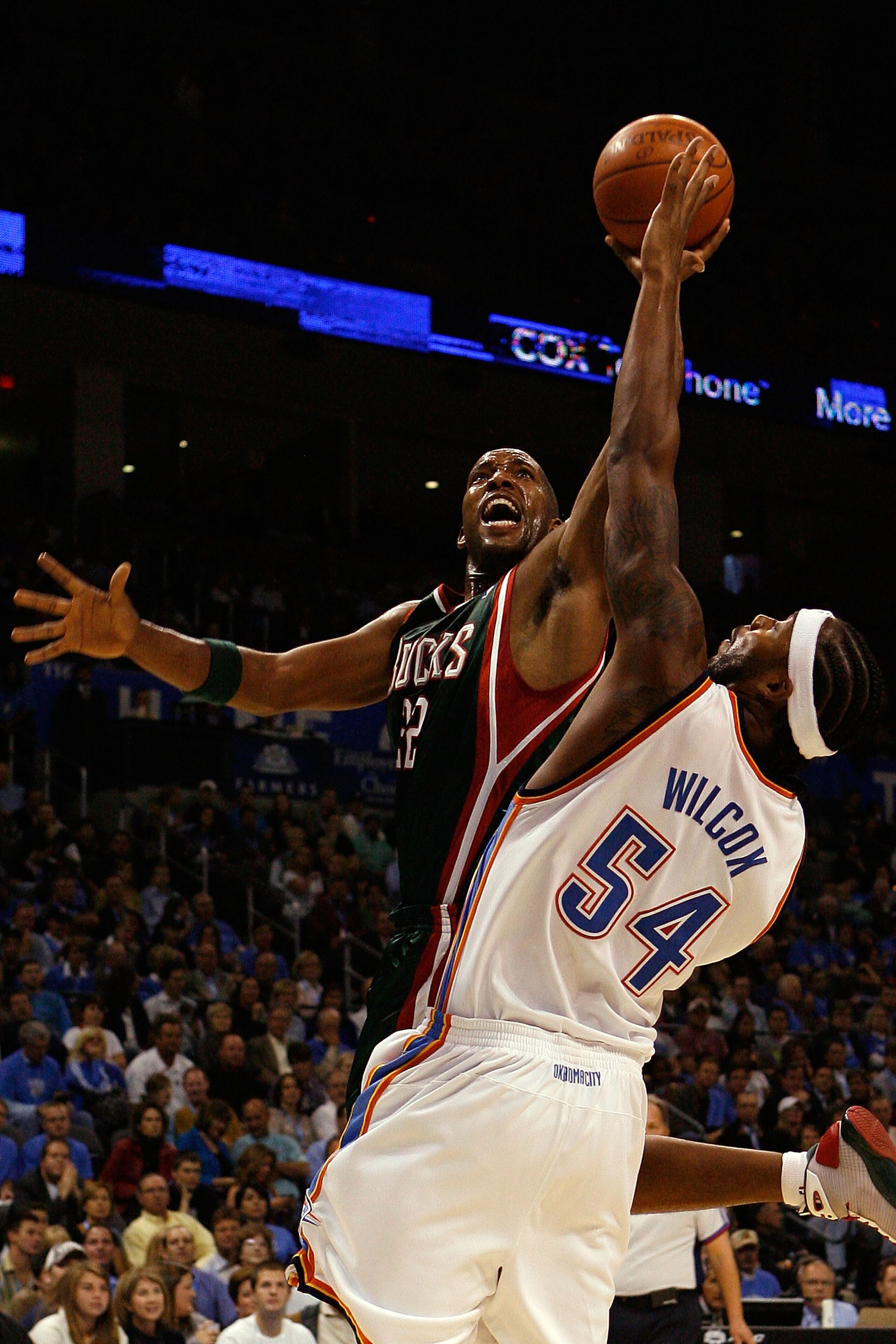 OKLAHOMA CITY - OCTOBER 29:  Michael Redd #22 of the Milwaukee Bucks makes a shot over Chris Wilcox #54 of the Oklahoma City Thunder at the Ford Center October 29, 2008 in Oklahoma City, Oklahoma. NOTE TO USER: User expressly acknowledges and agrees that,