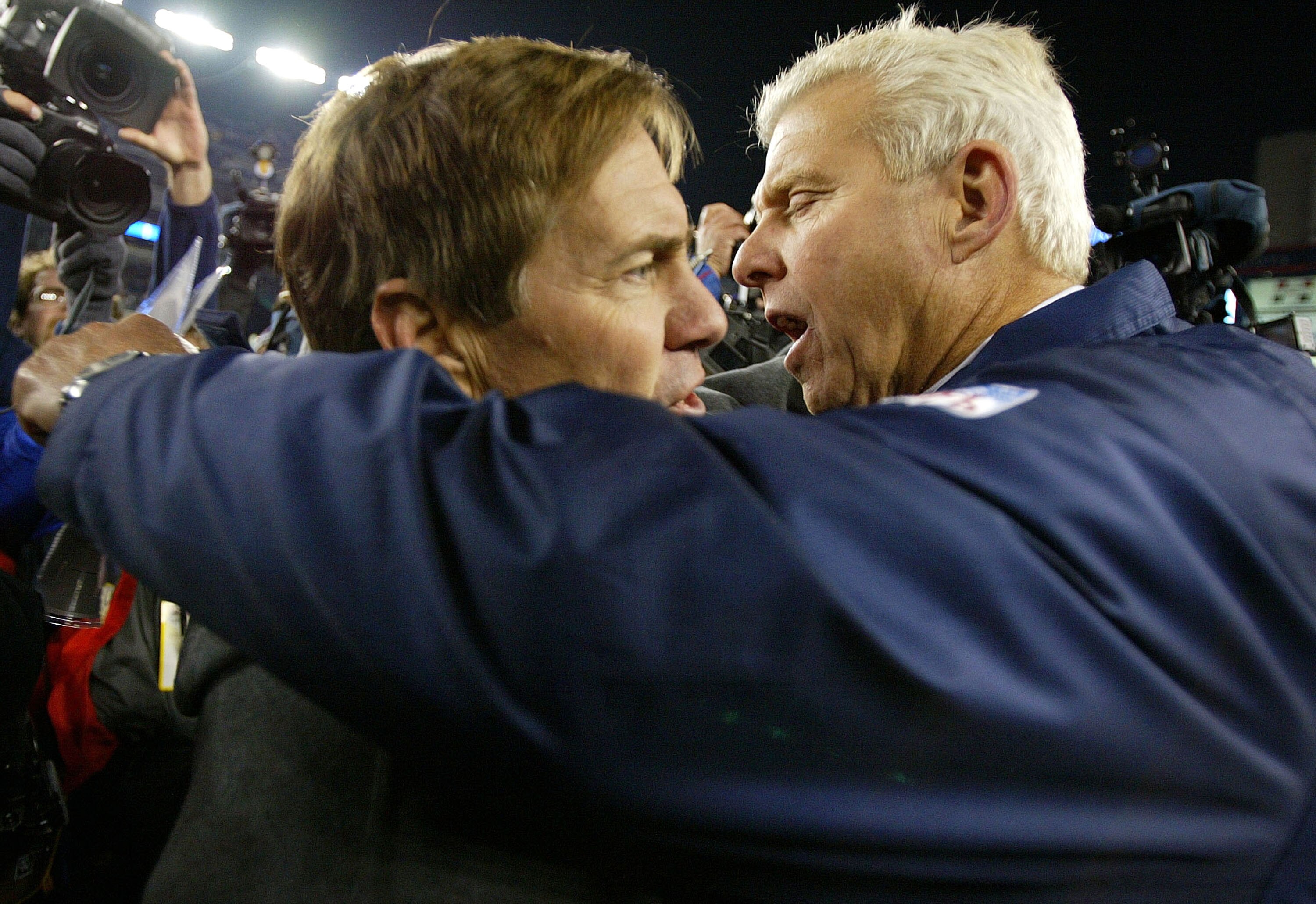 FOXBORO, MA - NOVEMBER 16:  Head Coach Bill Belichick of the New England Patriots (L) hugs Head Coach Bill Parcells of the Dallas Cowboys after the Patriots 12-0 win on November 16, 2003 at Gillette Stadium in Foxboro, Massachusetts.  (Photo by Al Bello/G