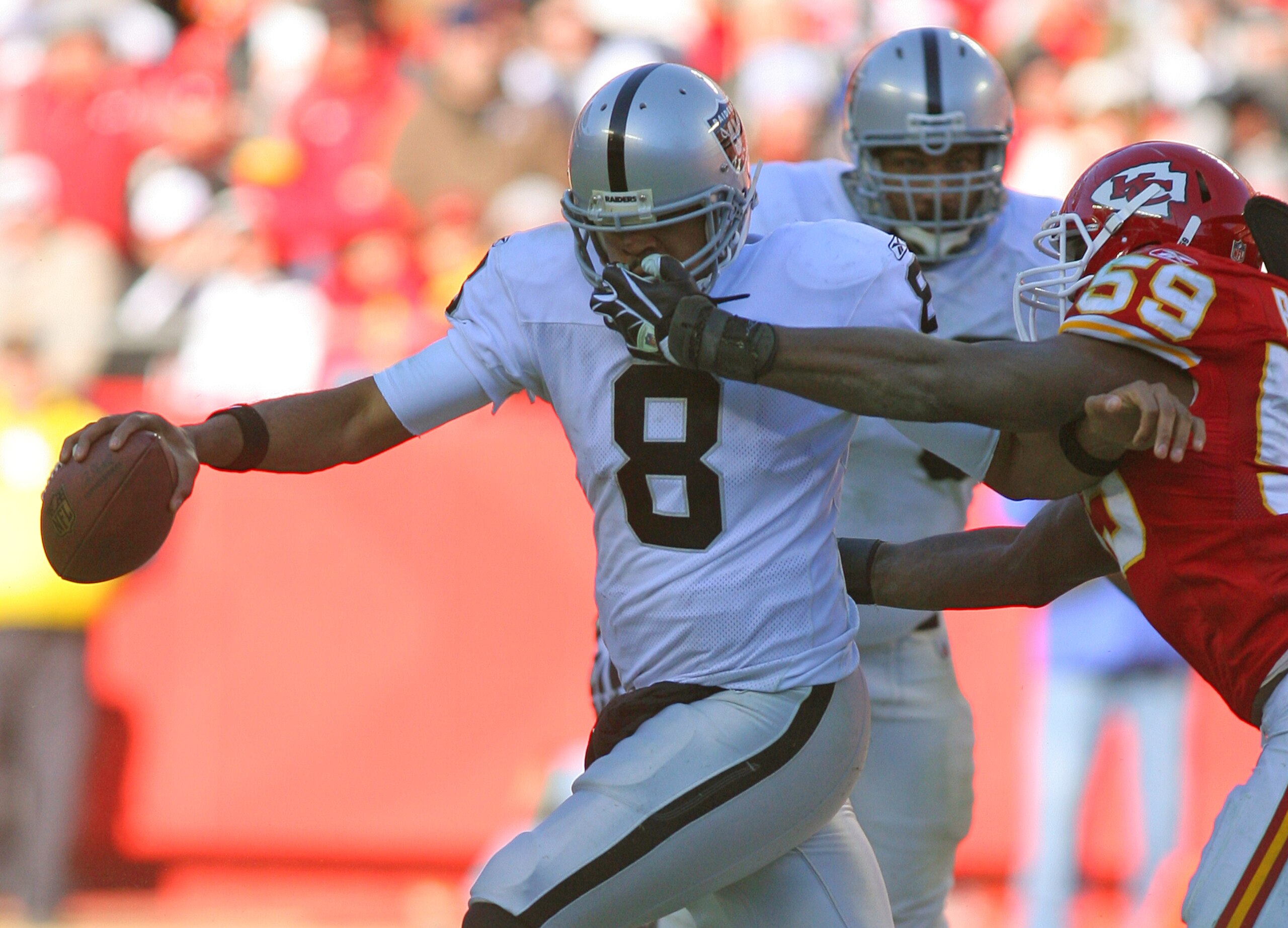 KANSAS CITY, MO - JANUARY 02:  Quarterback Jason Campbell #8 of the Oakland Raiders is sacked by linebacker Jovan Belcher #59 of the Kansas City Chiefs in a game at Arrowhead Stadium on January 2, 2011 in Kansas City, Missouri.  (Photo by Tim Umphrey/Gett