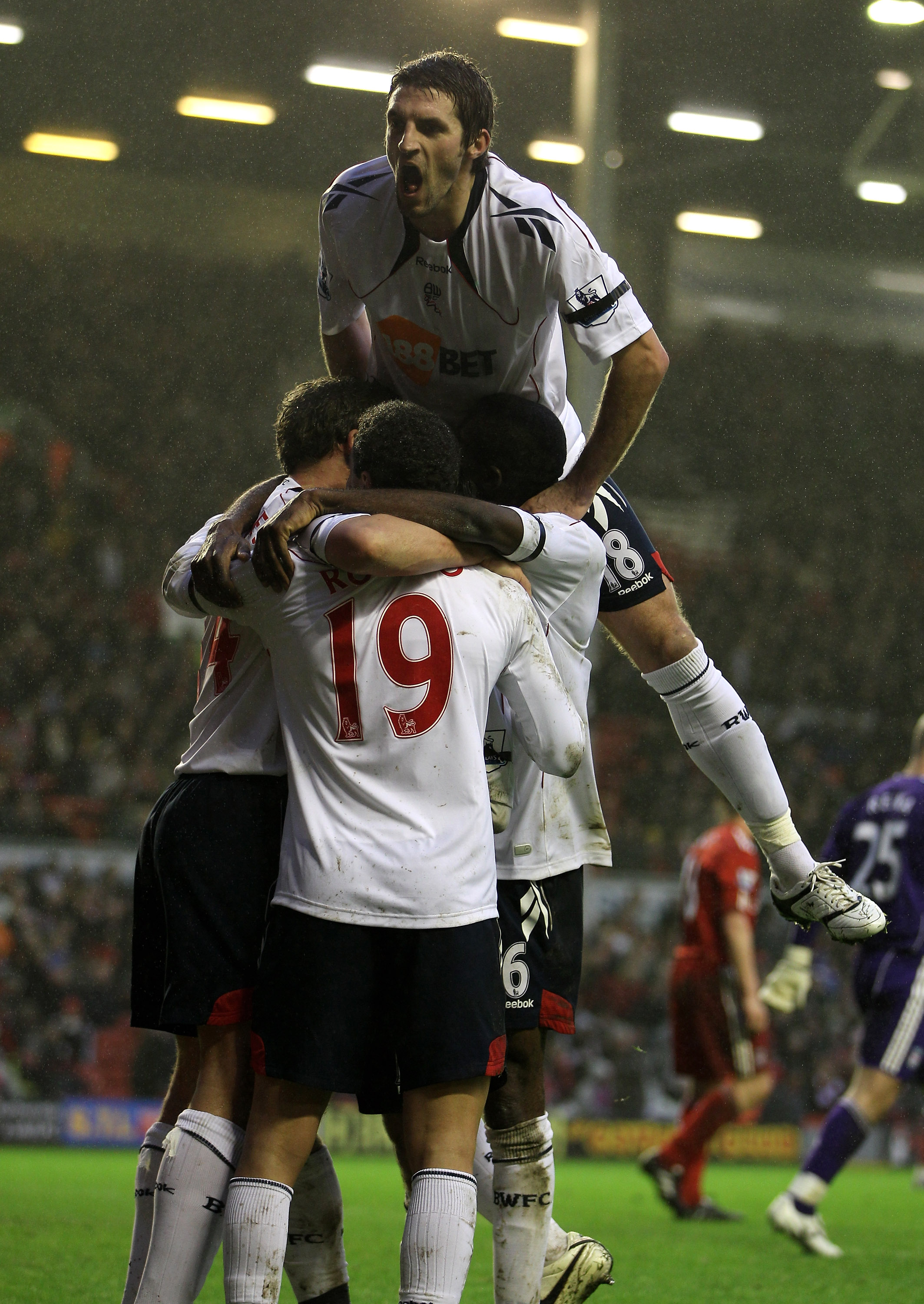 LIVERPOOL, ENGLAND - JANUARY 01:  Kevin Davies of Bolton Wanderers celebrates with his team mates after scoring the opening goal during the Barclays Premier League match between Liverpool and Bolton Wanderers at Anfield on January 1, 2011 in Liverpool, En