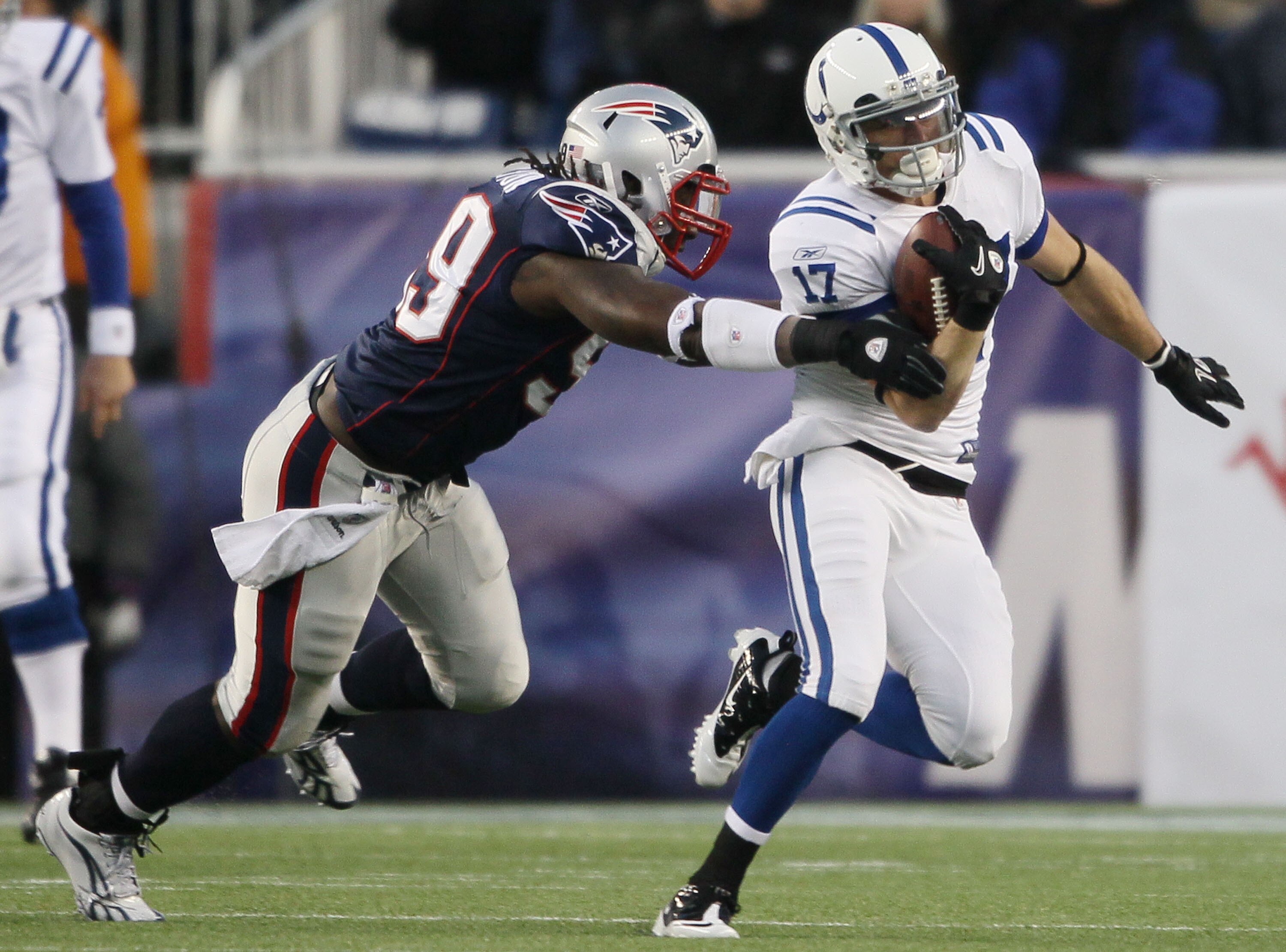FOXBORO, MA - NOVEMBER 21:  Austin Collie #17 of the Indianapolis Colts tries to get around Mike Wright #99 of the New England Patriots on November 21, 2010 at Gillette Stadium in Foxboro, Massachusetts. The Patriots defeated the Colts 31-28. (Photo by El