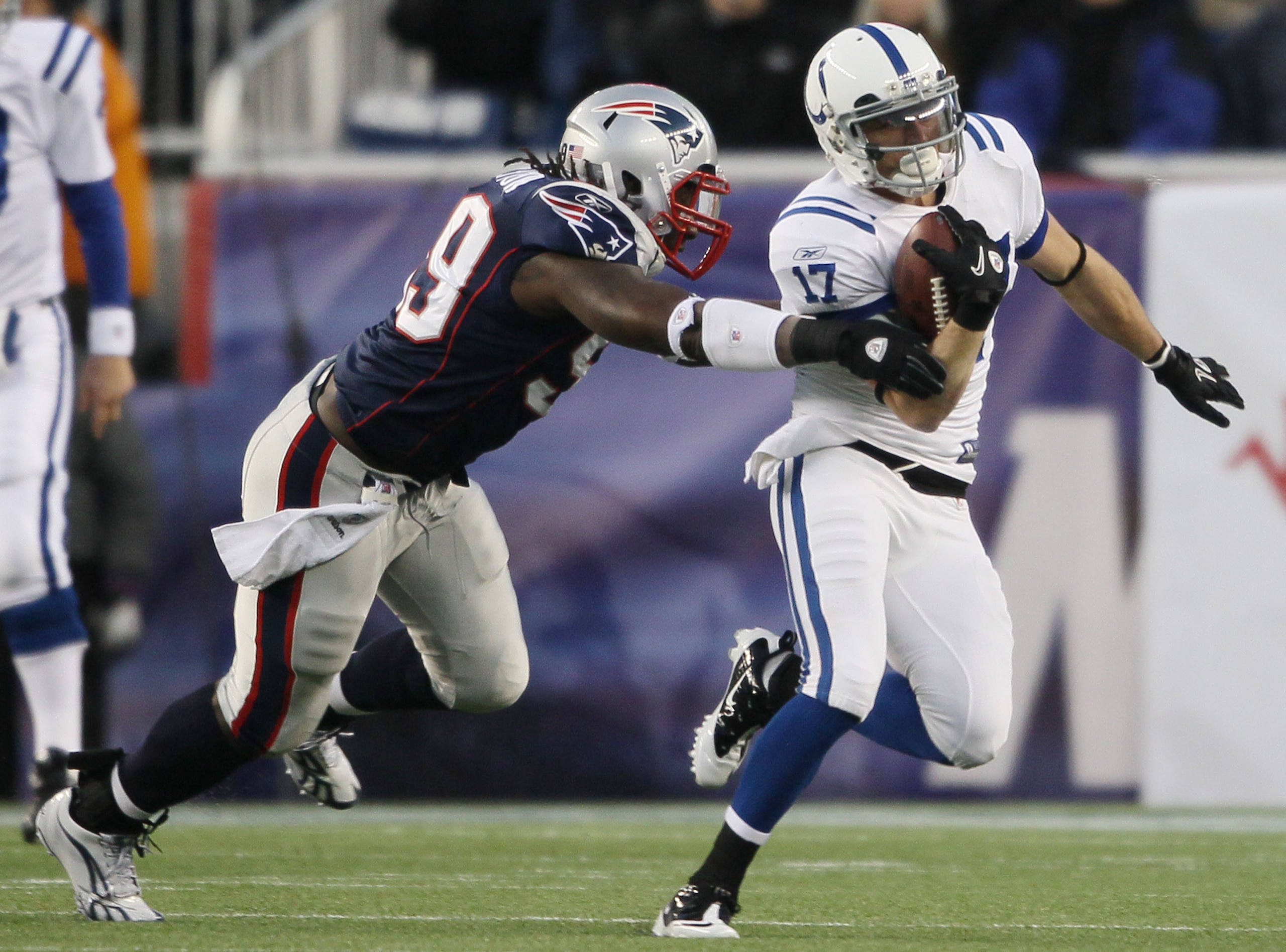 FOXBORO, MA - NOVEMBER 21:  Austin Collie #17 of the Indianapolis Colts tries to get around Mike Wright #99 of the New England Patriots on November 21, 2010 at Gillette Stadium in Foxboro, Massachusetts. The Patriots defeated the Colts 31-28. (Photo by El