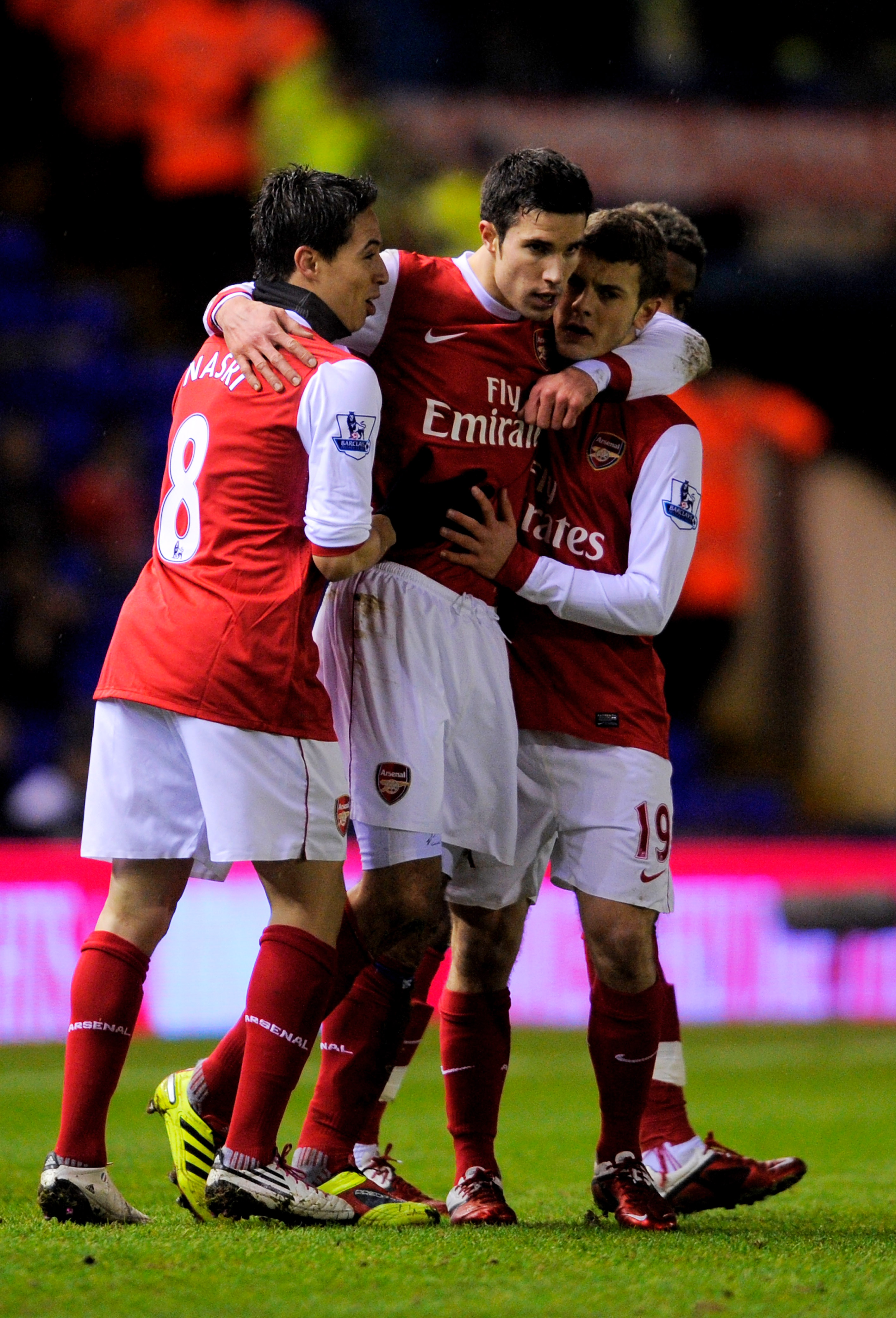 BIRMINGHAM, ENGLAND - JANUARY 01:  Robin Van Persie (C) of Arsenal is congratulated by teammates Samir Nasri (L) and Jack Wilshere (R) after scoring the opening goal of the match during the Barclays Premier Leaue match between Birmingham City and Arsenal