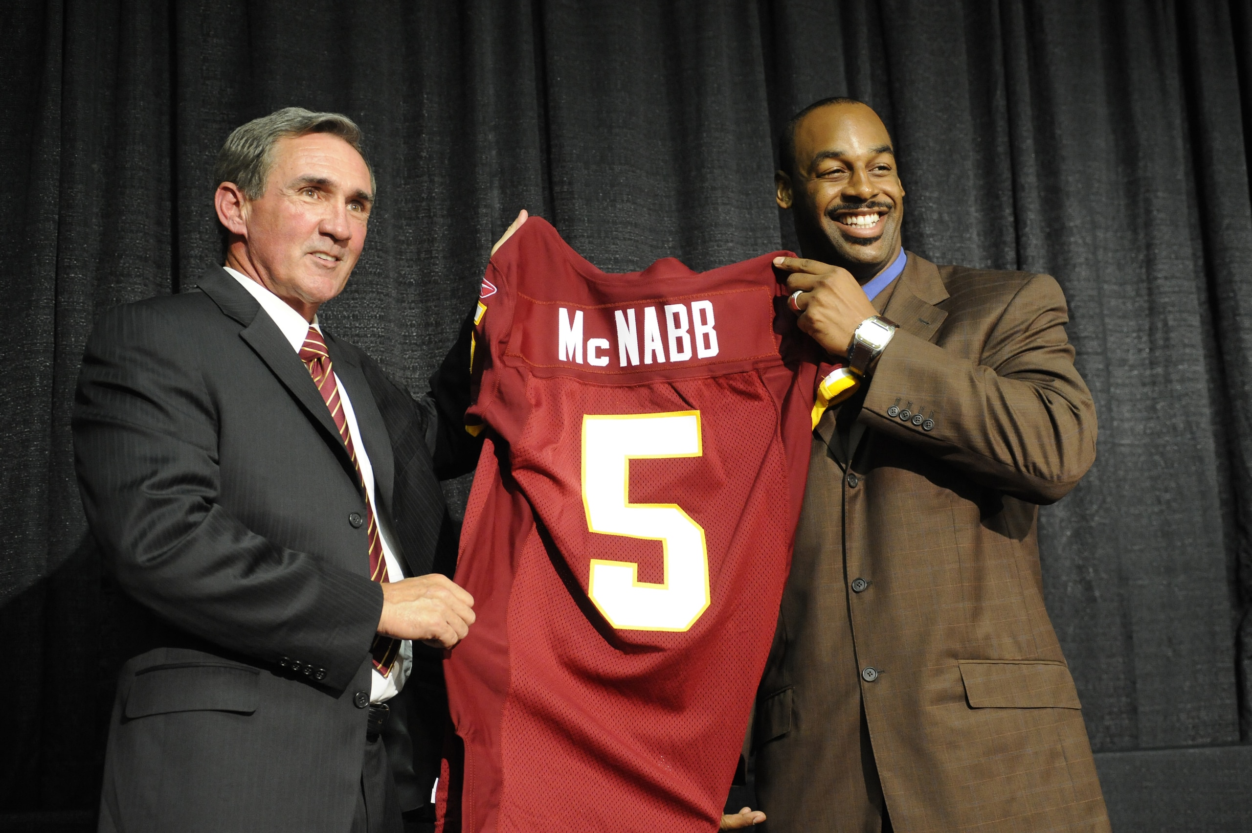 ASHURN, VA - APRIL 6: Mike Shanahan, head coach of the Washington Redskins presents Donovan McNabb with his new jersey during a press conference on April 6, 2010 at Redskin Park in Ashburn, Virginia. (Photo by Mitchell Layton/Getty Images) ASHURN, VA - APRIL 6: Mike Shanahan, head coach of the Washington Redskins presents Donovan McNabb with his new jersey during a press conference on April 6, 2010 at Redskin Park in Ashburn, Virginia. (Photo by Mitchell Layton/Getty Images)