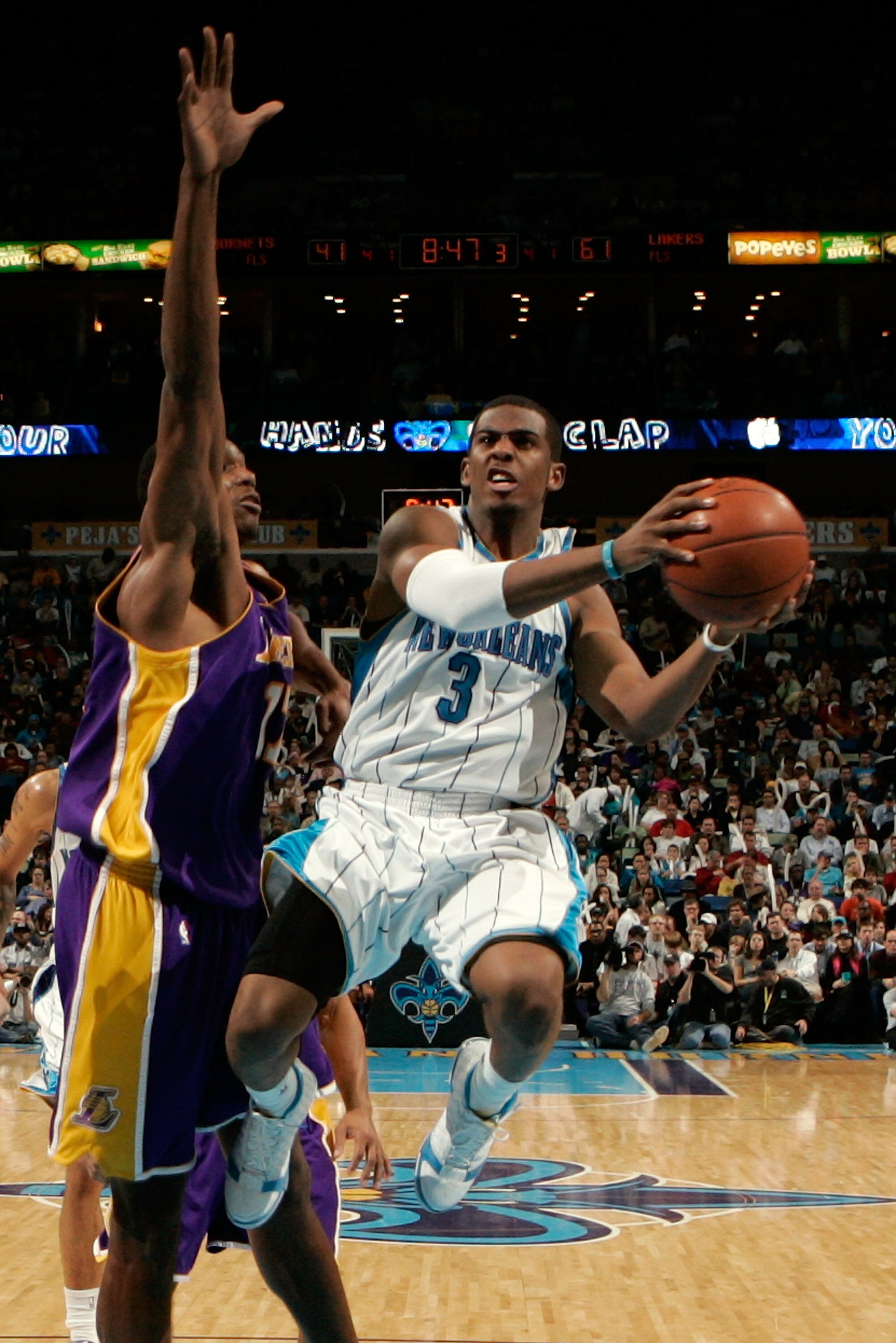 NEW ORLEANS - DECEMBER 23:  Chris Paul #3 of the New Orleans Hornets makes a shot over Andrew Bynum #17 of the Los Angeles Lakers on December 23, 2008 at the New Orleans Arena in New Orleans, Louisiana. The Lakers defeated the Hornets 100-87.   NOTE TO US