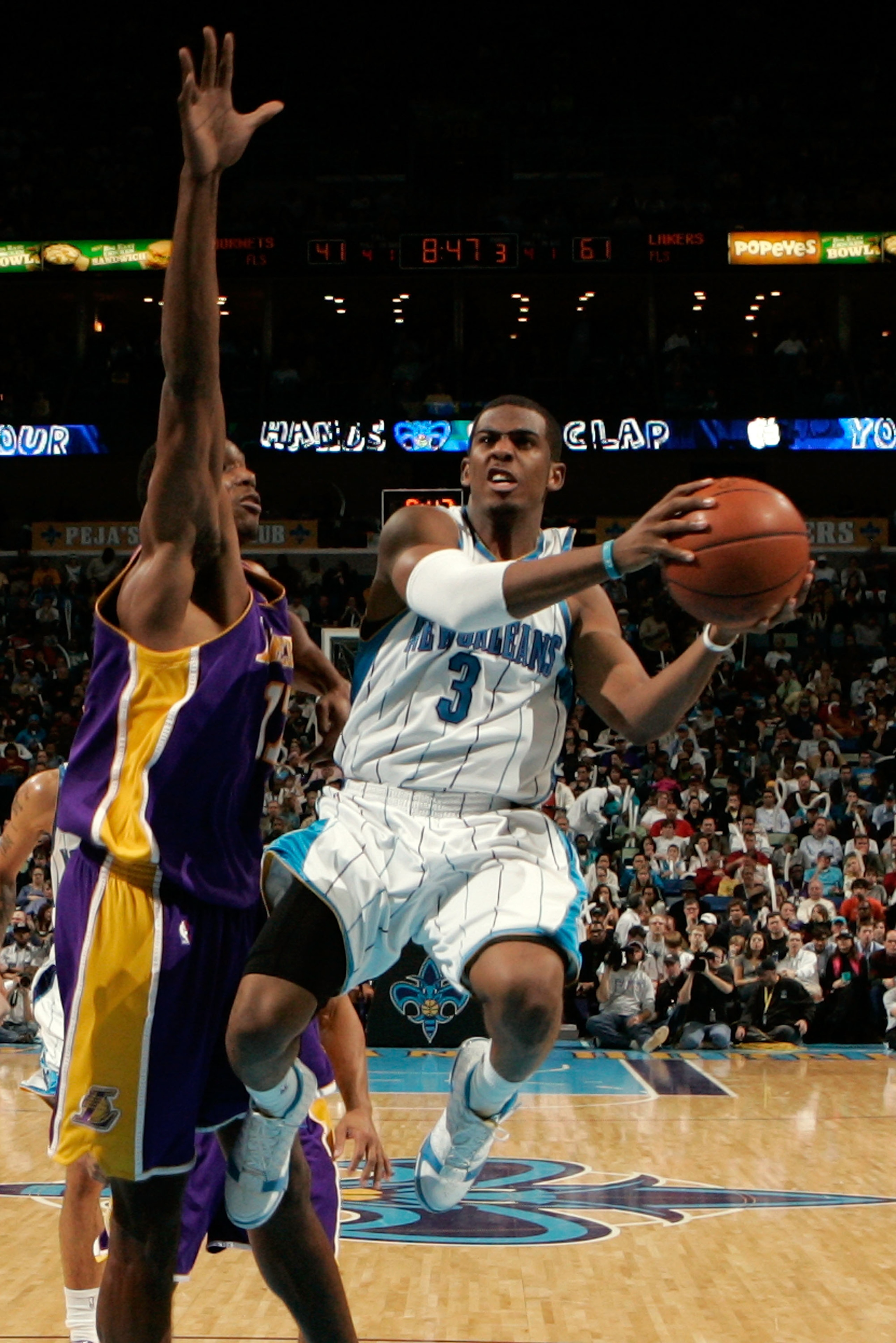 NEW ORLEANS - DECEMBER 23:  Chris Paul #3 of the New Orleans Hornets makes a shot over Andrew Bynum #17 of the Los Angeles Lakers on December 23, 2008 at the New Orleans Arena in New Orleans, Louisiana. The Lakers defeated the Hornets 100-87.   NOTE TO US