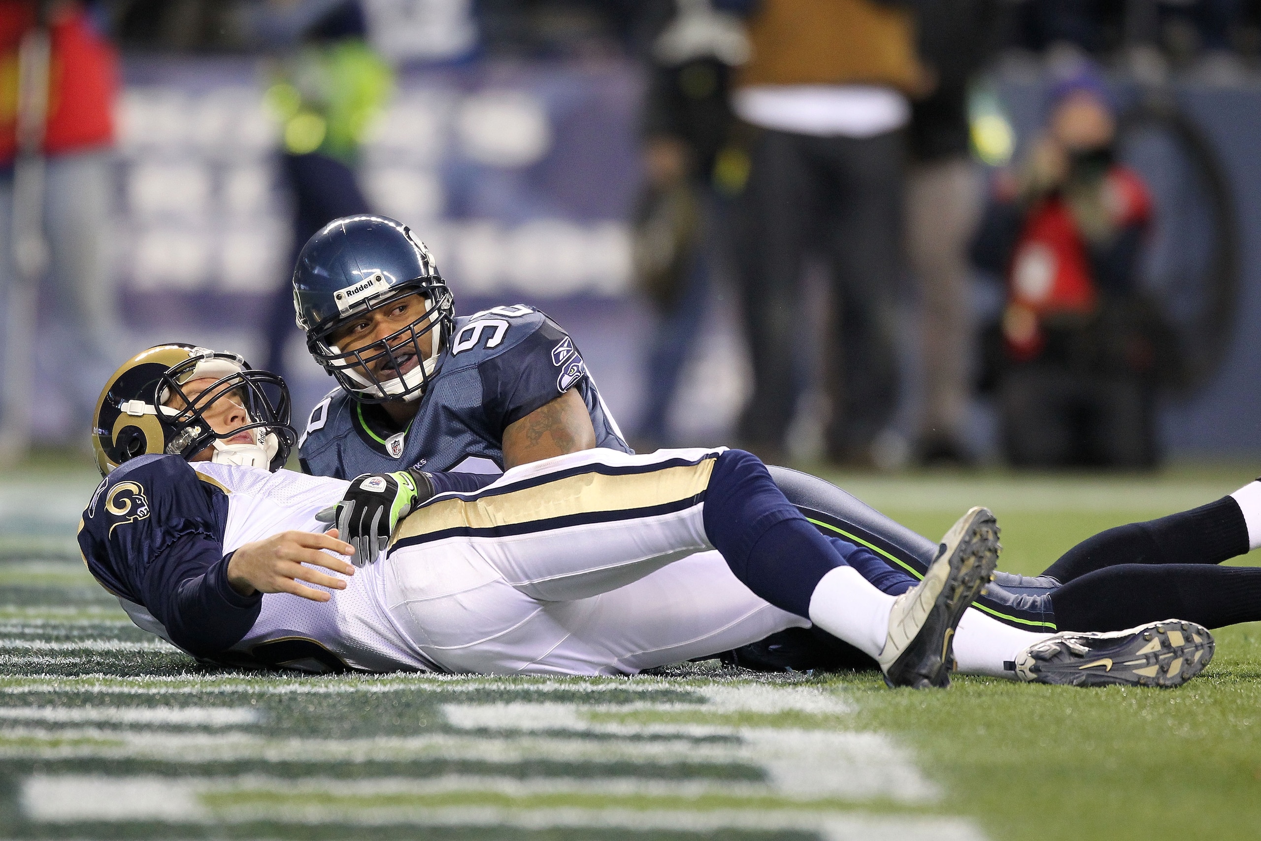 SEATTLE, WA - JANUARY 02: Quarterback Sam Bradford #8 of the St. Louis Rams lays on the ground after being hit by defensive end Raheem Brock #98 of the Seattle Seahawks during their game at Qwest Field on January 2, 2011 in Seattle, Washington. (Photo b SEATTLE, WA - JANUARY 02: Quarterback Sam Bradford #8 of the St. Louis Rams lays on the ground after being hit by defensive end Raheem Brock #98 of the Seattle Seahawks during their game at Qwest Field on January 2, 2011 in Seattle, Washington. (Photo b