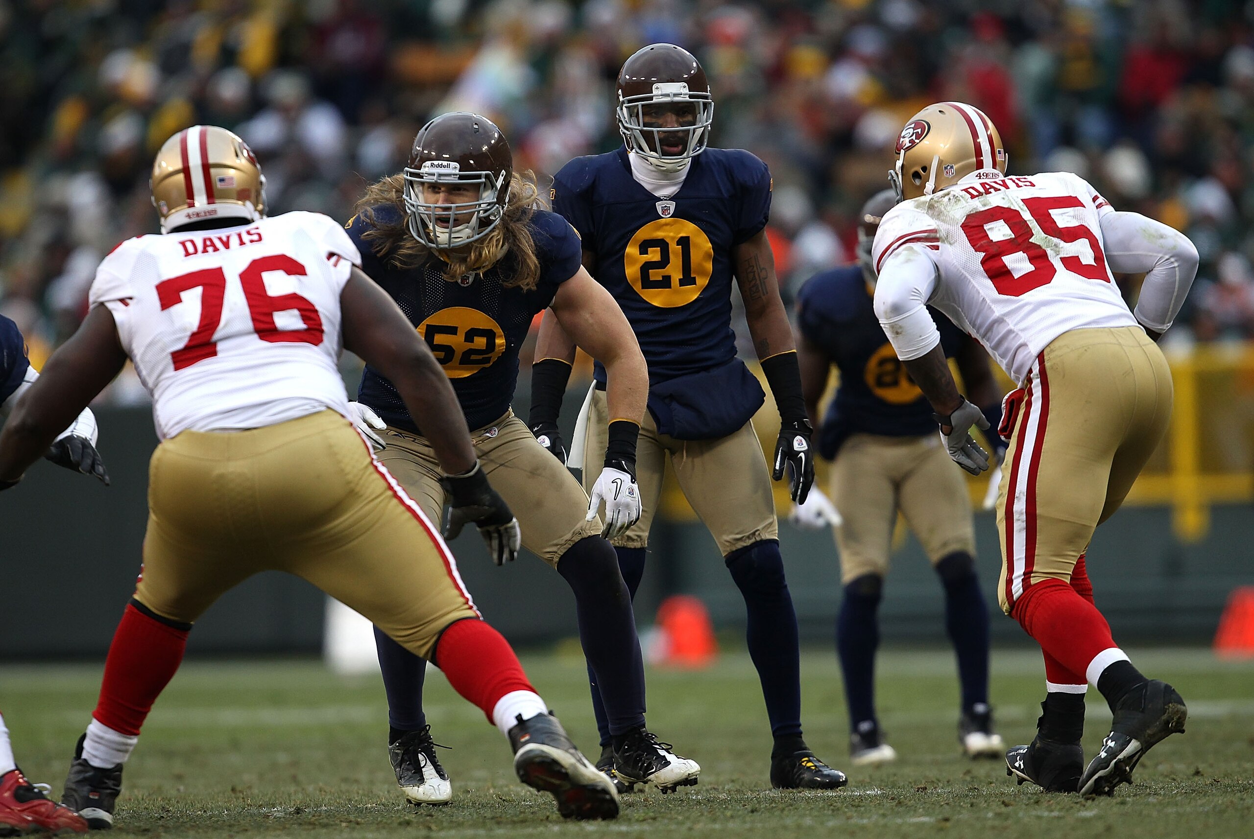 GREEN BAY, WI - DECEMBER 05: Clay Matthews #52 and Charles Woodson #12 of the Green Bay Packers prepare to take on Anthony Davis #76 and Vernon Davis #85 of the San Francisco 49ers at Lambeau Field on December 5, 2010 in Green Bay, Wisconsin. The Packers
