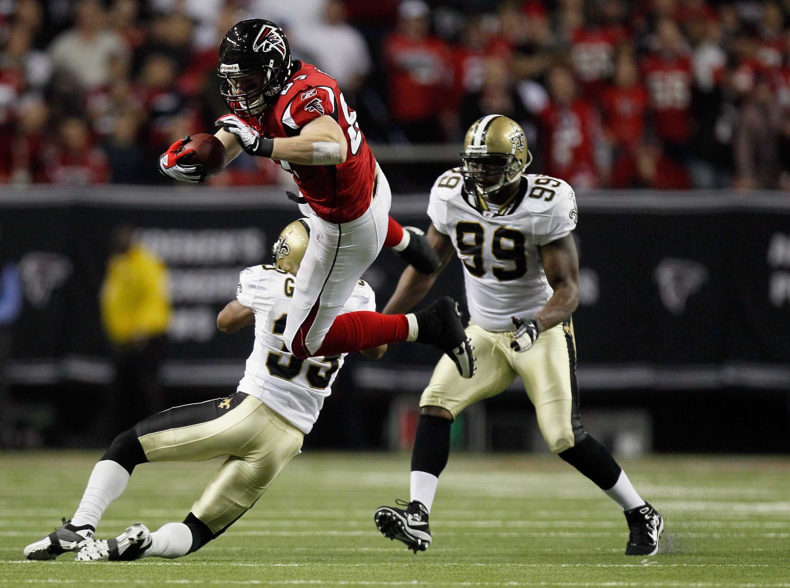 ATLANTA, GA - DECEMBER 27:  Justin Peelle #87 of the Atlanta Falcons goes up and over the tackle of Jabari Greer #33 of the New Orleans Saints during their game at the Georgia Dome on December 27, 2010 in Atlanta, Georgia.  (Photo by Kevin C. Cox/Getty Im