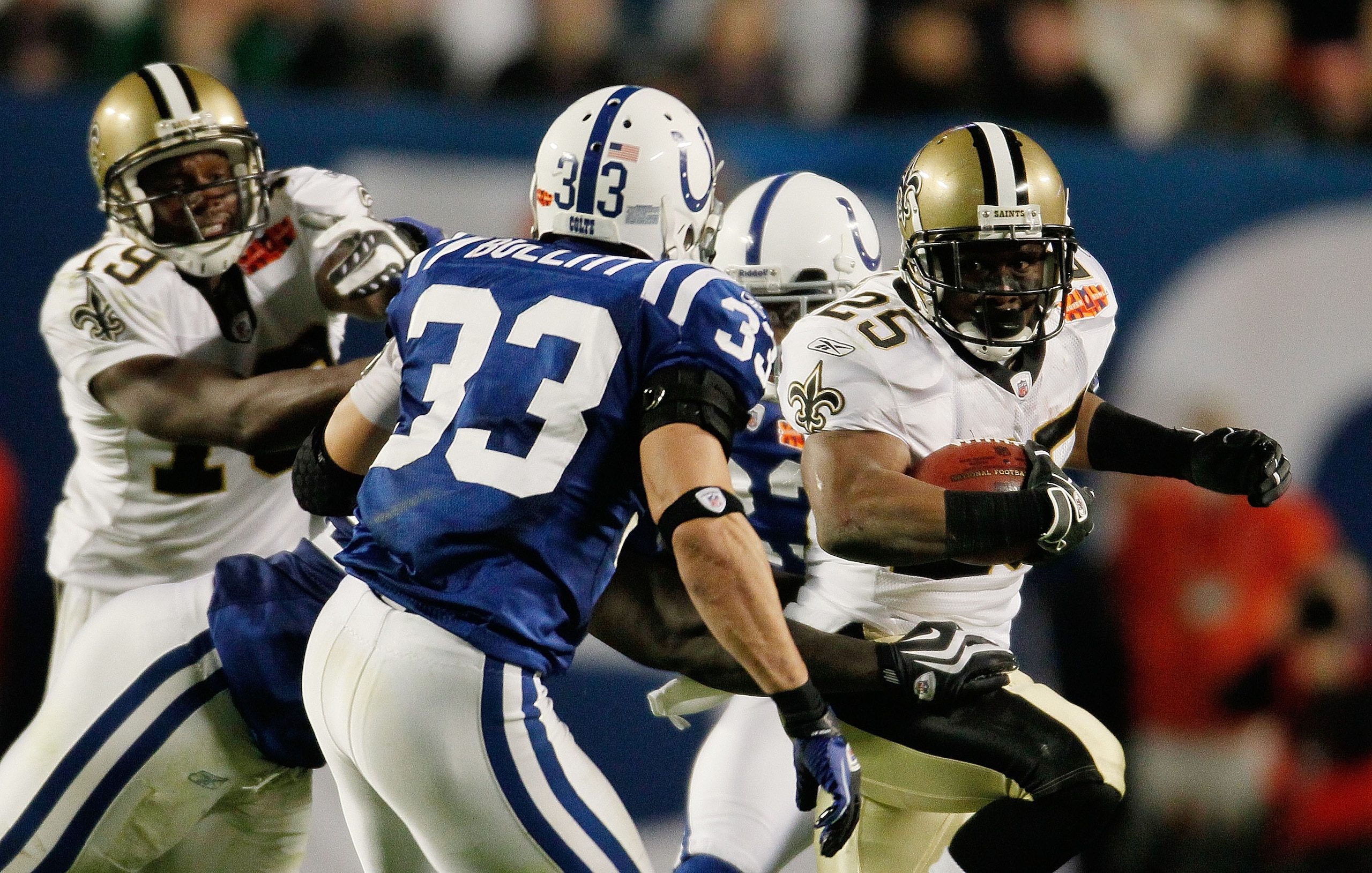 MIAMI GARDENS, FL - FEBRUARY 07: Reggie Bush #25 of the New Orleans Saints runs with the ball against Melvin Bullitt #33 of the Indianapolis Colts during Super Bowl XLIV on February 7, 2010 at Sun Life Stadium in Miami Gardens, Florida.  (Photo by Donald