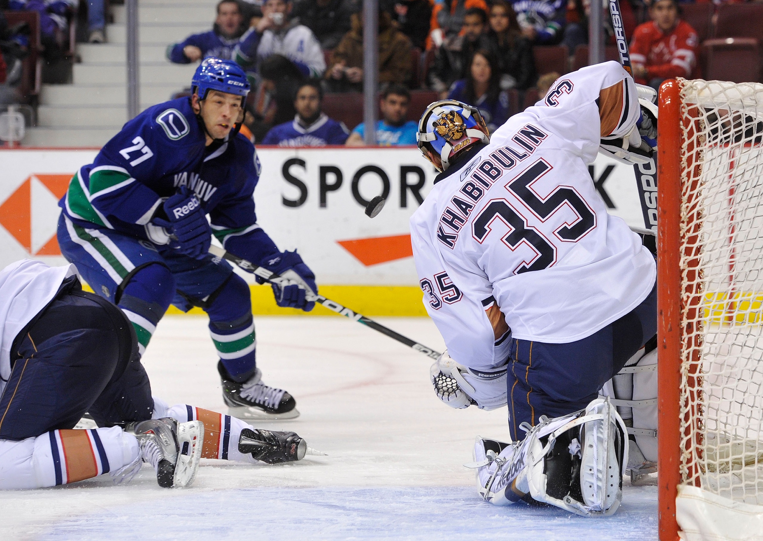 VANCOUVER, CANADA - DECEMBER 26: Manny Malhotra #27 of the Vancouver Canucks is stopped by Nikolai Khabibulin #35 of the Edmonton Oilers during the second period in NHL action on December 26, 2010 at Rogers Arena in Vancouver, BC, Canada.  (Photo by Rich