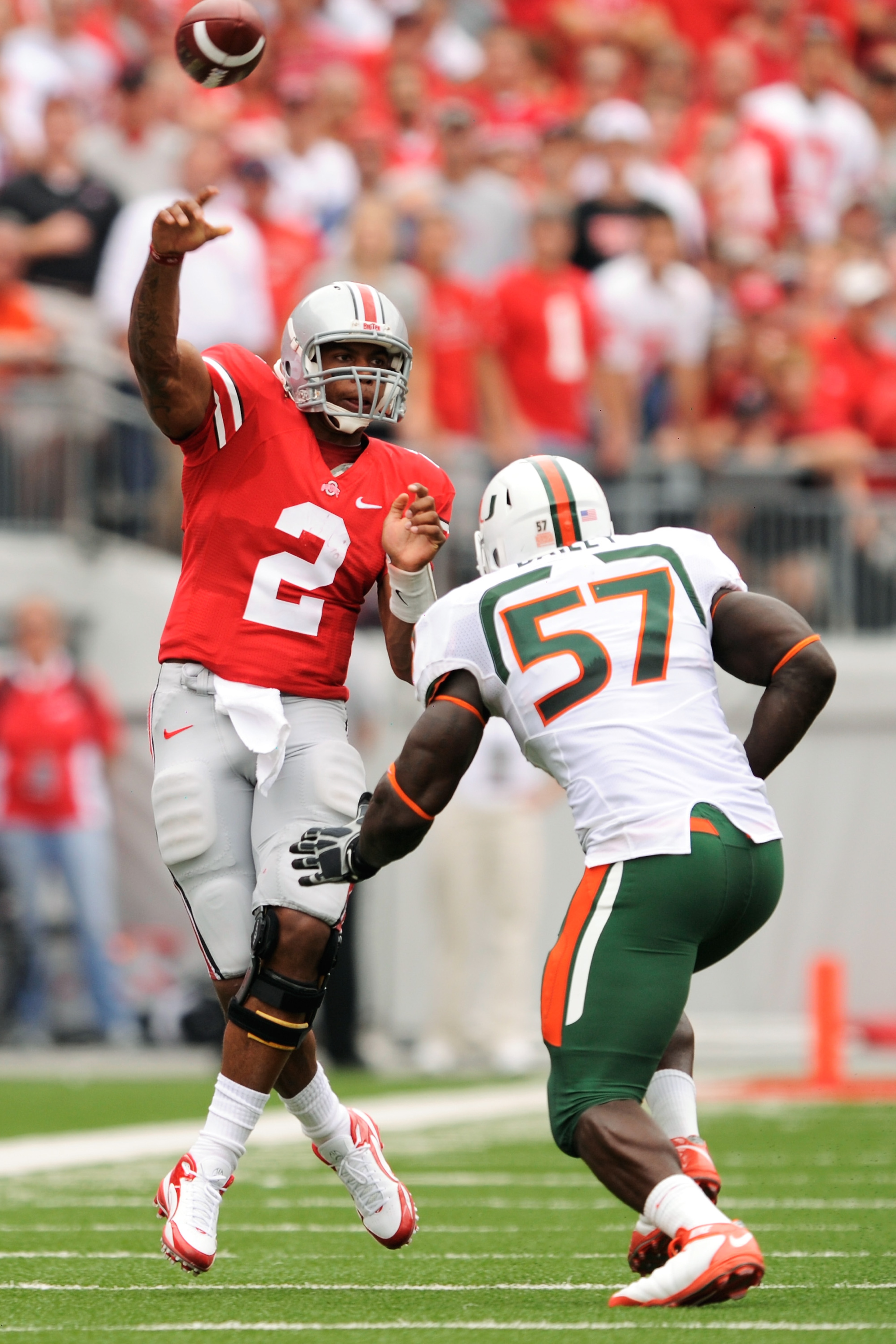 COLUMBUS, OH - SEPTEMBER 11: Quarterback Terrelle Pryor #2 of the Ohio State Buckeyes gets off a pass as Allen Bailey #57 of the Miami Hurricanes applies pressure at Ohio Stadium on September 11, 2010 in Columbus, Ohio. (Photo by Jamie Sabau/Getty Image COLUMBUS, OH - SEPTEMBER 11: Quarterback Terrelle Pryor #2 of the Ohio State Buckeyes gets off a pass as Allen Bailey #57 of the Miami Hurricanes applies pressure at Ohio Stadium on September 11, 2010 in Columbus, Ohio. (Photo by Jamie Sabau/Getty Image