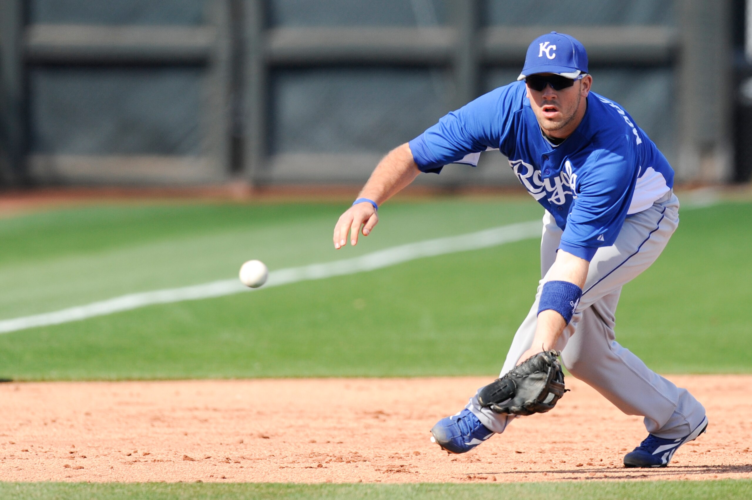 SURPISE, AZ - FEBRUARY 27: Mike Moustakas #8 of the Kansas City Royals field a ground ball during a spring training game against the Texas Rangers at Surprise Stadium on February 27, 2011 in Surprise, Arizona. (Photo by Rob Tringali/Getty Images)