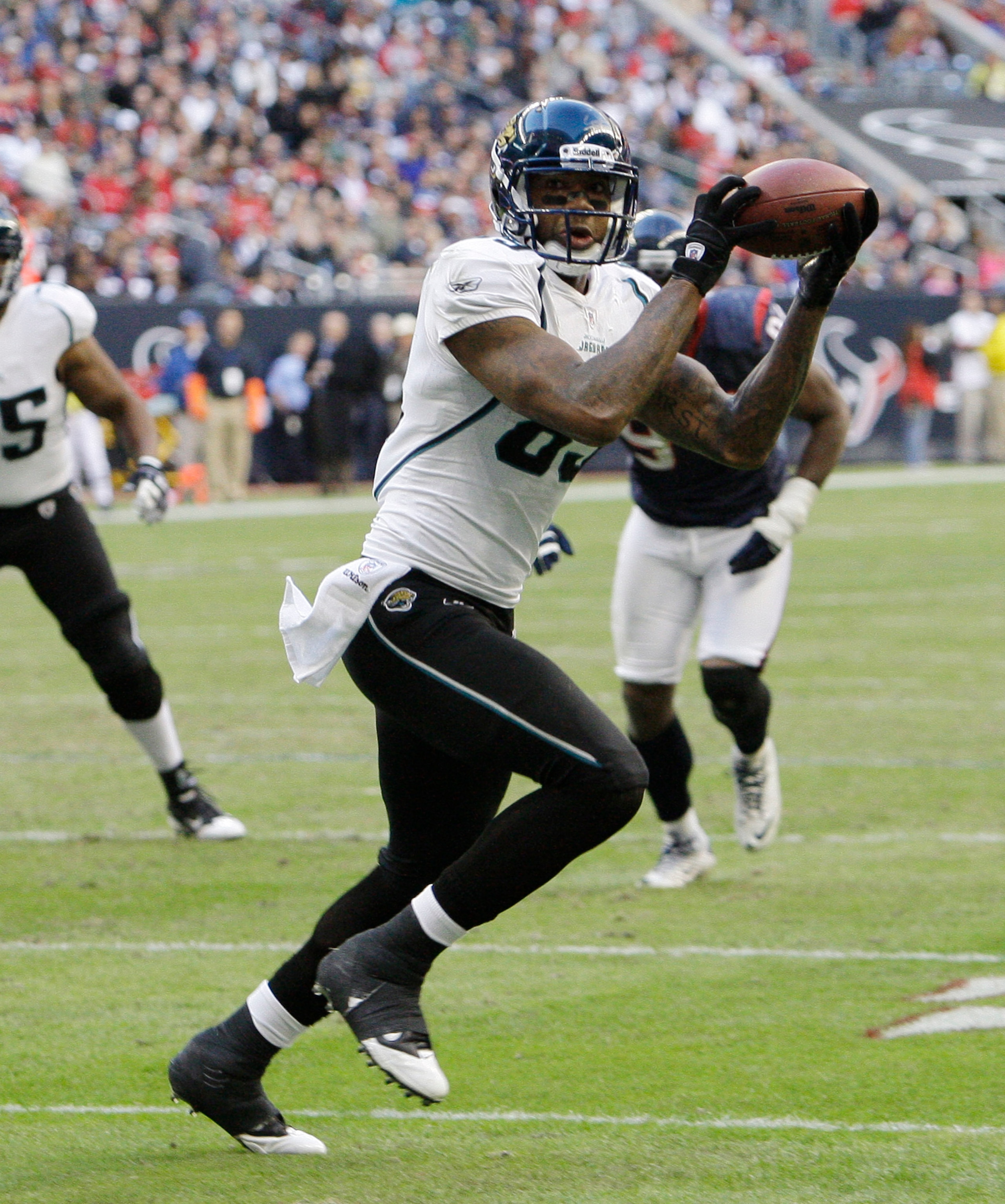 HOUSTON - JANUARY 02:  Wide receiver Mike Thomas #80 of the Jacksonville Jaguars scores in the second quarter against the Houston Texans at Reliant Stadium on January 2, 2011 in Houston, Texas.  (Photo by Bob Levey/Getty Images)