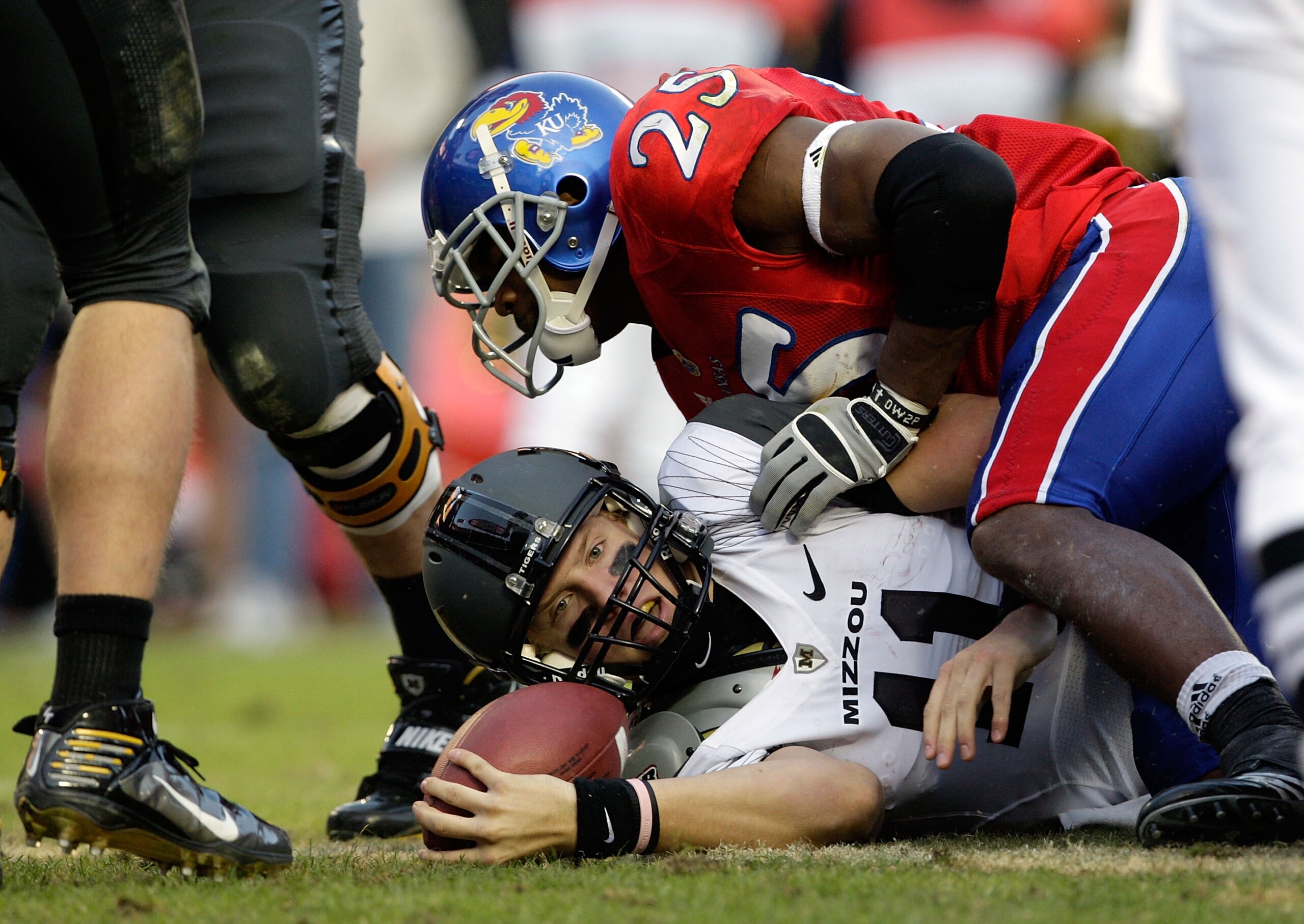 KANSAS CITY, MO - NOVEMBER 28:  Quarterback Blaine Gabbert #11 of the Missouri Tigers is tackled short of the end zone by Darrell Stuckey #25 of the Kansas Jayhawks during the game at Arrowhead Stadium on November 28, 2009 in Kansas City, Missouri.  (Phot