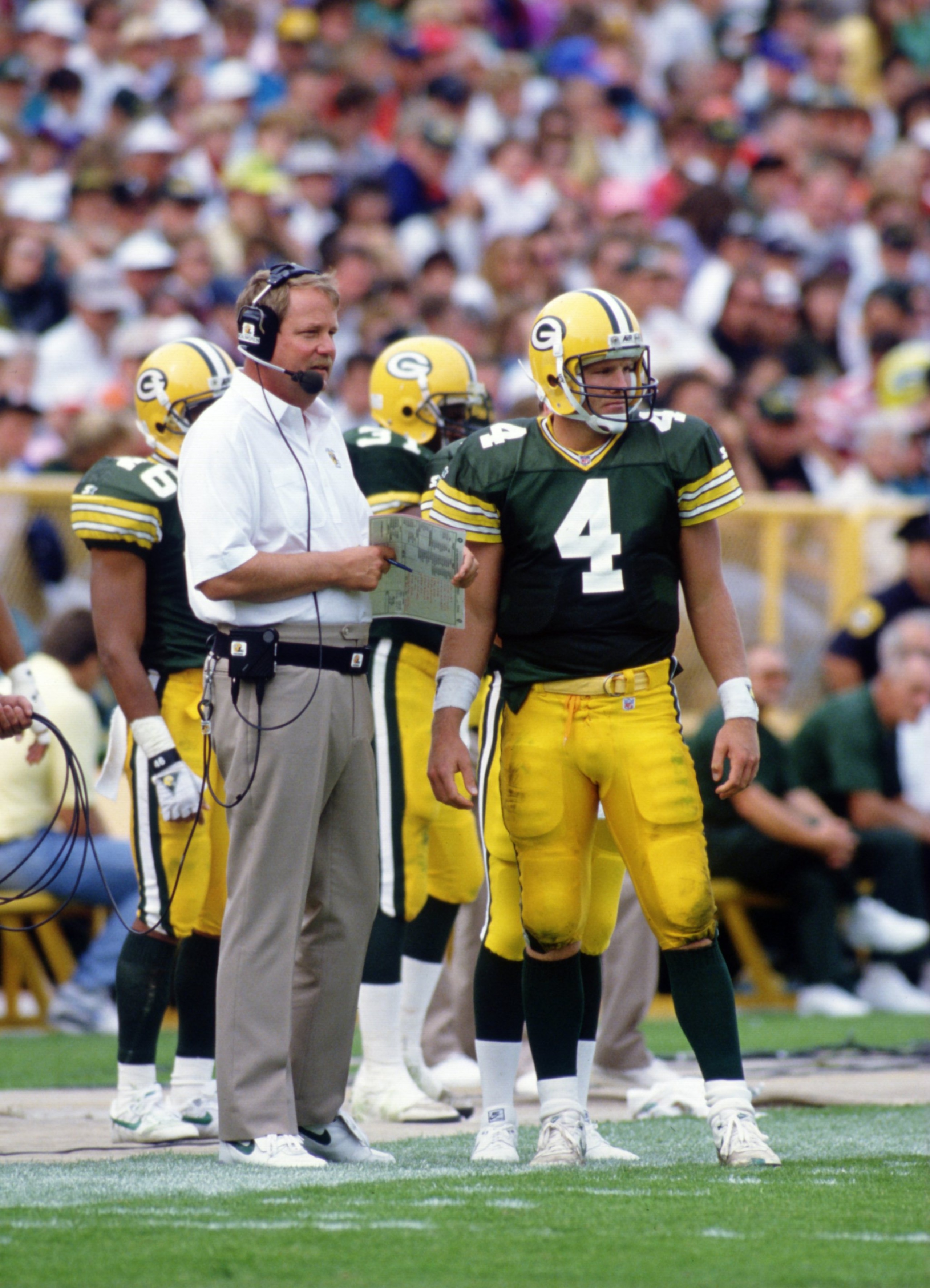 20 SEP 1992:  HEAD COACH MIKE HOLMGREN OF THE GREEN BAY PACKERS TALKS TO QUARTERBACK BRETT FAVRE DURING THE PACKERS 24-23 WIN OVER THE CINCINNATI BENGALS AT LAMBEAU FIELD IN GREEN BAY, WISCONSIN. Mandatory Credit: Jonathan Daniel/ALLSPORT