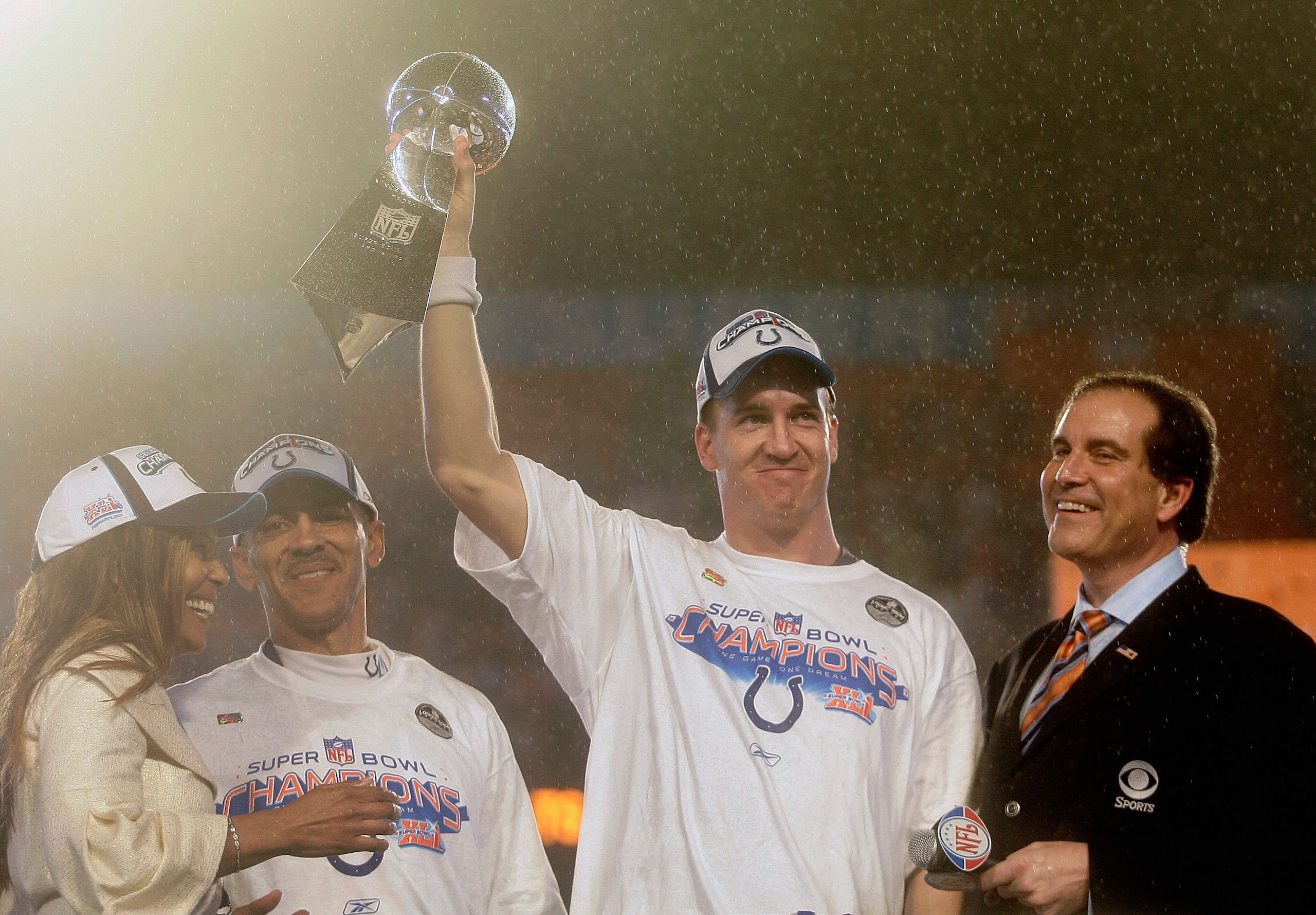 MIAMI GARDENS, FL - FEBRUARY 04: Quarterback Peyton Manning #18 of the Indianapolis Colts celebrates with the Vince Lombardi Super Bowl trophy next to head coach Tony Dungy and is wife, Lauren, and CBS sports broadcaster Jim Nantz after winning the Super MIAMI GARDENS, FL - FEBRUARY 04: Quarterback Peyton Manning #18 of the Indianapolis Colts celebrates with the Vince Lombardi Super Bowl trophy next to head coach Tony Dungy and is wife, Lauren, and CBS sports broadcaster Jim Nantz after winning the Super