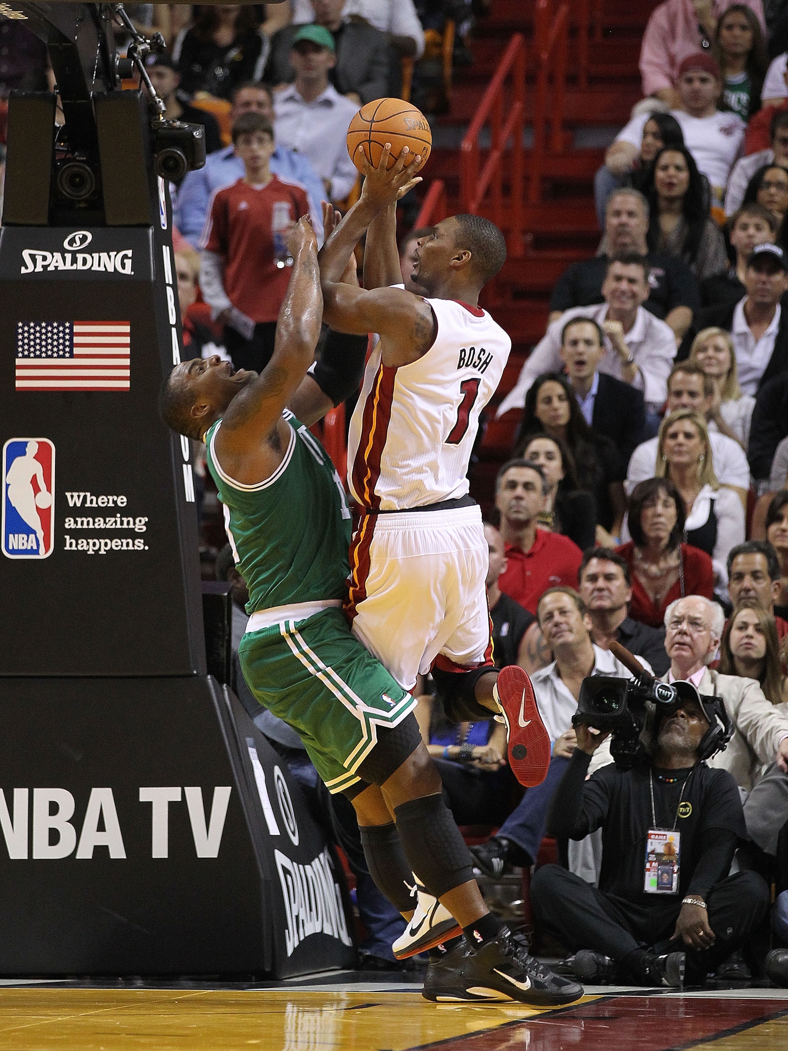 MIAMI - NOVEMBER 11:   Chris Bosh #1 of the Miami Heat takes a shot against Glen Davis #11 during a game against the Boston Celtics at American Airlines Arena on November 11, 2010 in Miami, Florida. NOTE TO USER: User expressly acknowledges and agrees tha