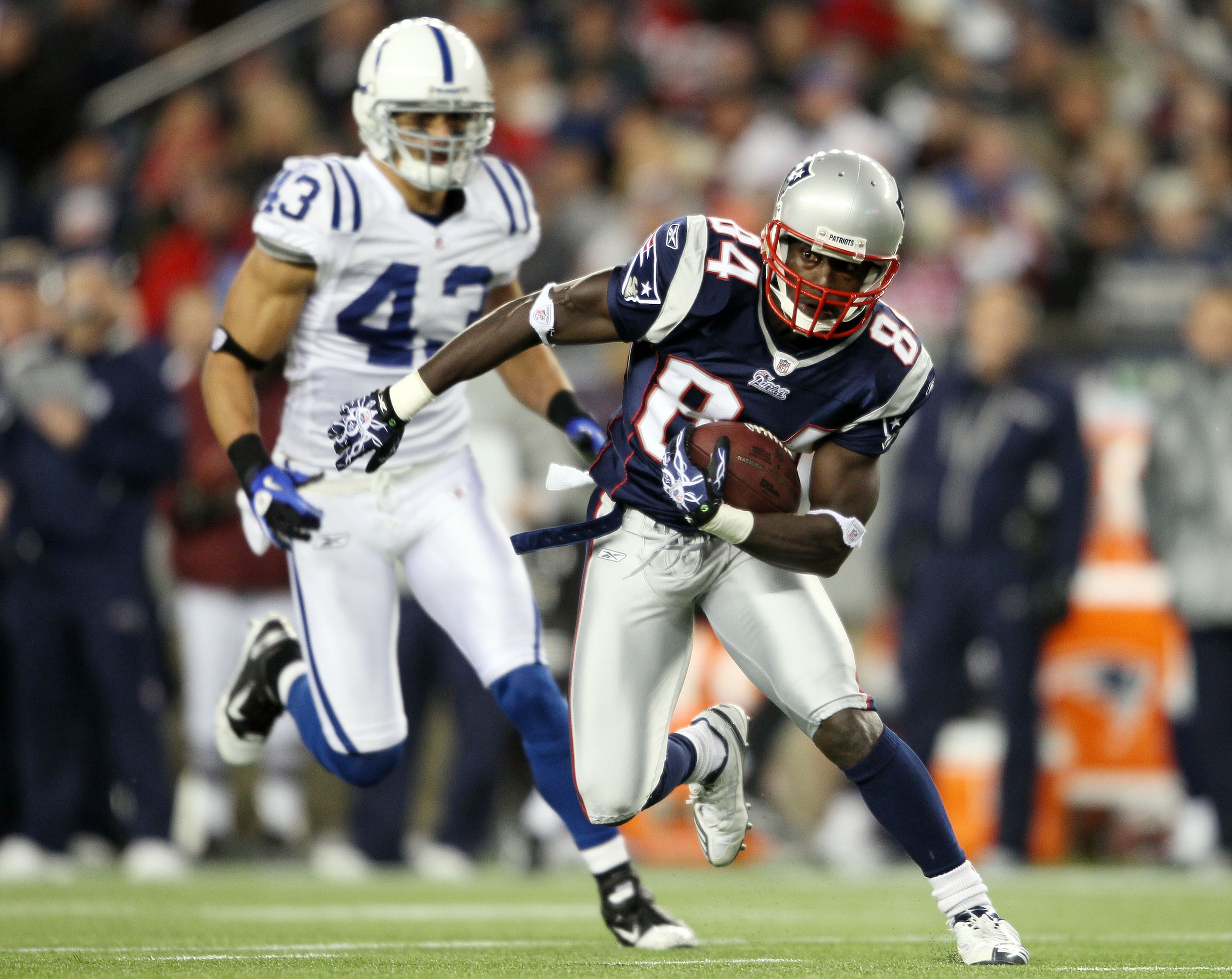 FOXBORO, MA - NOVEMBER 21:   Deion Branch #84 of the New England Patriots carries the ball as Aaron Francisco #43 of the Indianapolis Colts chases on November 21, 2010 at Gillette Stadium in Foxboro, Massachusetts. The Patriots defeated the Colts 31-28. (