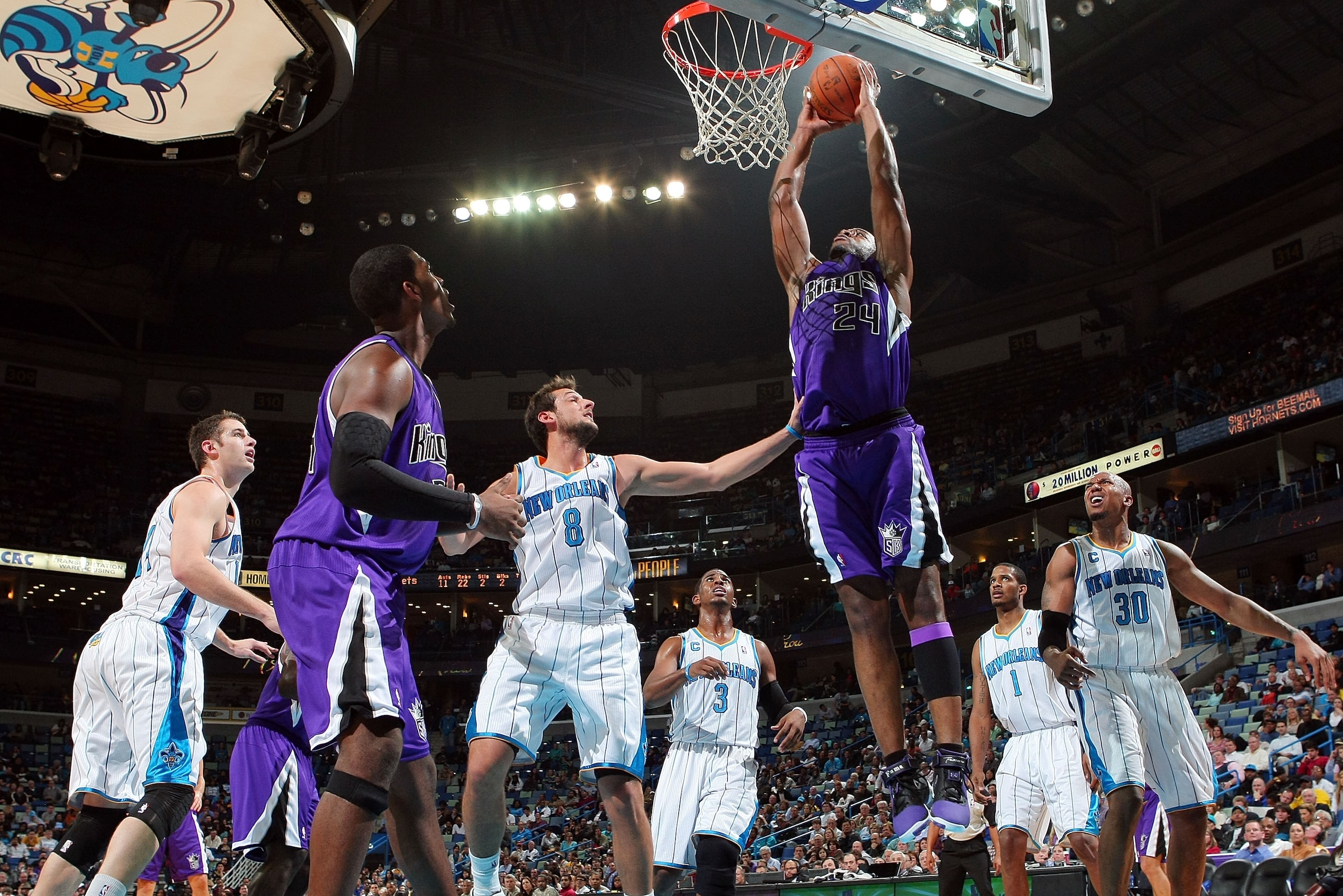 NEW ORLEANS, LA - DECEMBER 15:  Carl Landry #24 of the Sacramento Kings dunks the ball over Marco Belinelli #8 of the New Orleans Hornets  at the New Orleans Arena on December 15, 2010 in New Orleans, Louisiana.  NOTE TO USER: User expressly acknowledges
